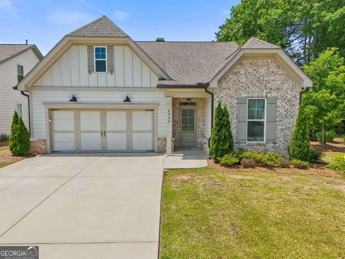 Welcome to 2335 Plummer Pl - A Stunning Showcase of Comfort, Style & Southern Charm! Prepare to fall in love with this beautifully maintained gem nestled in one of Marietta's most sought-after neighborhoods! From the moment you arrive, the amazing curb appeal, lush landscaping, and low-voltage landscape lighting invite you in for a closer look-and what awaits inside is even more impressive. Step through the front door (complete with Brinks home push, pull, twist door handles) to be greeted by gleaming hardwood floors throughout the entire main level, creating a seamless and elegant feel. The family room is a true showstopper, featuring custom vaulted ceilings, a cozy fireplace, and built-in shelving and storage-perfect for displaying your favorite pieces or keeping things organized in style. The heart of the home-the kitchen-is every chef's dream. You'll find stunning granite countertops, a gorgeous center island ideal for entertaining or casual dining, an oversized kitchen pantry, and abundant cabinet space to meet all your storage needs. It opens beautifully into the living and dining areas, making it the perfect space for hosting friends or enjoying family time. Ceiling fans have been added to both upstairs and downstairs bedrooms for extra comfort year-round. Retreat to the spacious master bedroom, complete with its own vaulted ceiling and a spa-like en suite featuring his and hers sinks and custom tilework that adds a touch of luxury. The custom shelving in the master bedroom closets and downstairs spare bedroom brings both style and organization to everyday living. Upstairs, you'll find new StainMaster carpet with Elite 8 lb padding, offering plush comfort throughout the second floor. And tucked away in the attic is a true hidden gem: a custom heated and air-conditioned storage room and workshop with built-in bench-perfect for hobbies, seasonal storage, or anything you can imagine. Tile in all bathrooms and the laundry room completes the home with durability and elegance in every corner. With its perfect blend of sophistication and warmth, this home is move-in ready and designed to impress. When it's time to relax in the fresh air, the custom finished, oversized, and fully enclosed, screened patio invites you to take your shoes off and sit a spell. This custom finished retreat is complete with custom tile, a ceiling fan and dog door, and leads you to the oversized, fully fenced back yard, offering total privacy and partial shade year round. Whether you're entertaining in the open-concept living spaces, enjoying quiet moments in the light-filled sunroom, or retreating to one of the beautifully updated bedrooms, 2335 Plummer Pl is a place you'll be proud to call home. Don't wait-homes this well-appointed in Marietta don't last long. Schedule your private tour today!