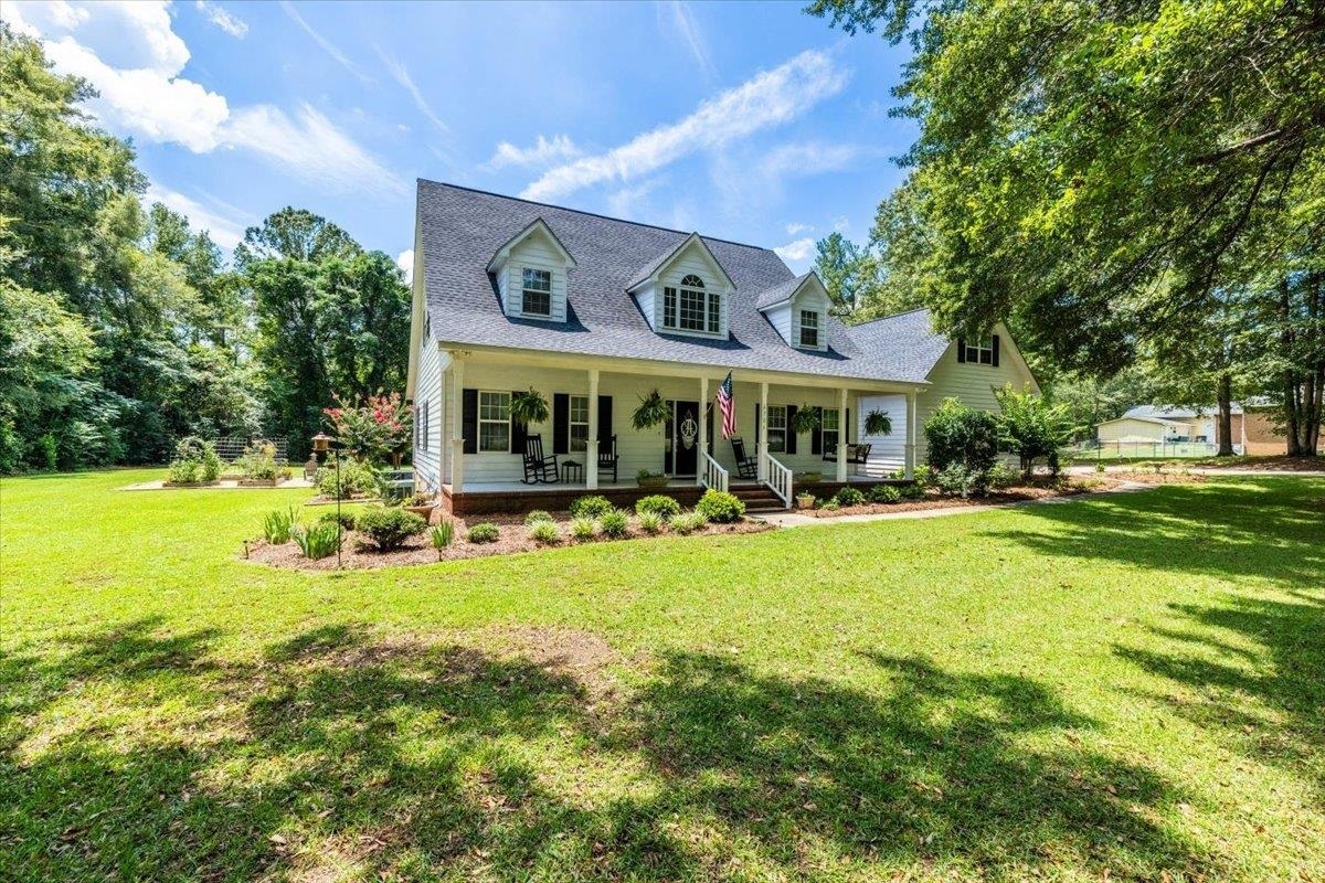 This home has the ''wow factor'' you are looking for! No need to do a thing here, just bring your things and enjoy your beautiful new home! Already updated from top to bottom, this special place has been meticulously maintained and is truly move-in ready. The three bedrooms are exceptionally spacious and the huge bonus room could serve as a home office, playroom, media room or peaceful retreat. The double stairs make access between floors a breeze. The setting for outdoor living is wonderful here! The front and back porches stretch the length of the home and offer lots of space for entertaining or for enjoying the peace and quiet. There is even a screened porch area which is perfect for enjoying outdoor meals. Green thumbs will love the garden! Those that appreciate a workshop will be blown away by the abundance of space for all of your tools and equipment in the dedicated area off the two car garage. With over an acre of land, there is plenty of space here to enable you to live the life you have always envisioned!