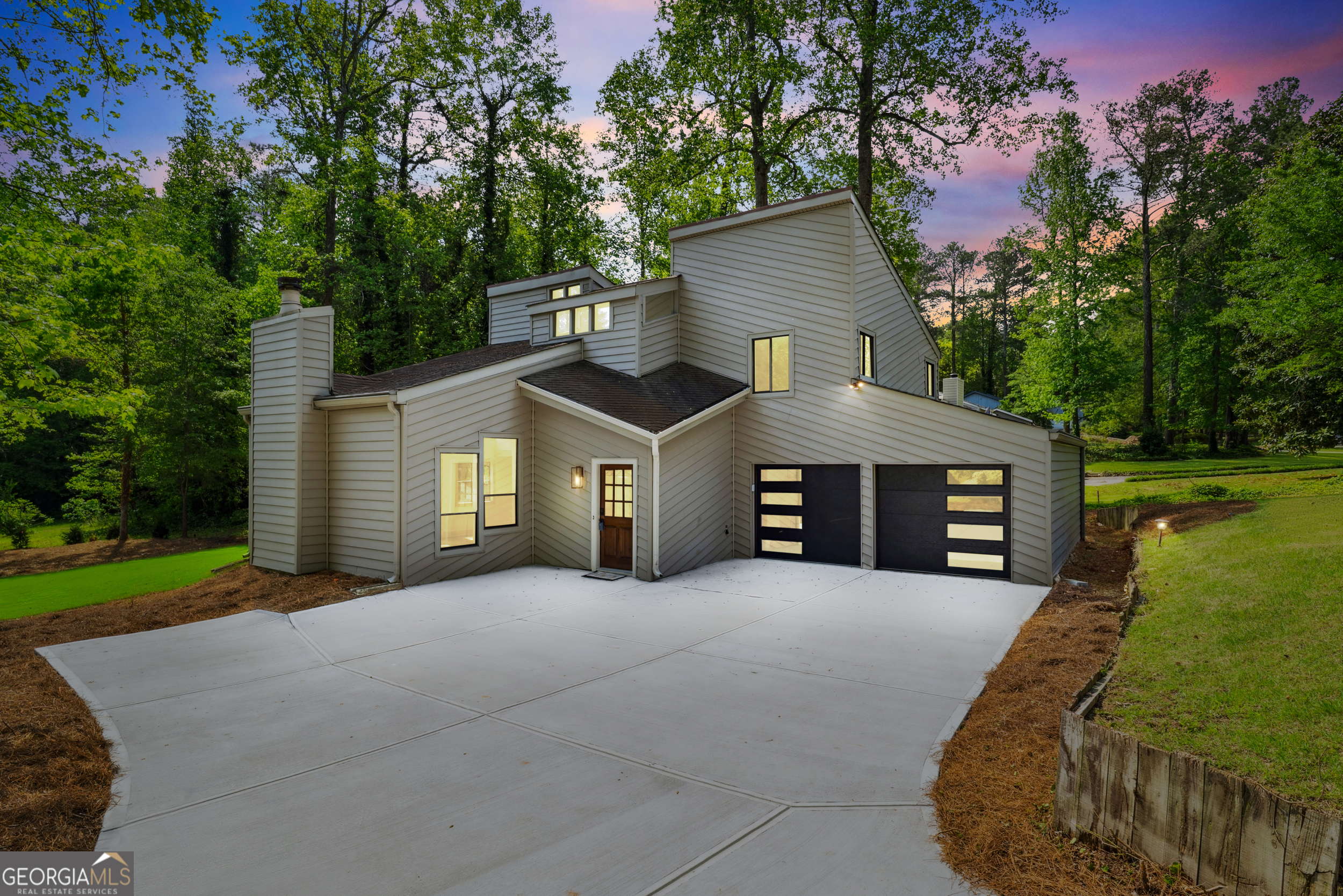 Fully renovated contemporary home in the coveted Pope High School District, just minutes from shopping, dining, parks, and only 6.8 miles from downtown Roswell. This modern stunner features a dramatic two-story family room with skylights, sleek new stair railings, luxury vinyl plank flooring with upgraded moldings, and a level backyard perfect for entertaining. The kitchen and bathrooms have been beautifully updated with soft-close cabinetry, quartz countertops, designer tile, stylish fixtures, and custom lighting. The primary suite boasts vaulted ceilings and additional skylights in both the bedroom and spa-like bath. Additional upgrades include new doors and hardware, new garage doors, a new hot water heater, recessed can lighting, and detailed trim work throughout. Located in an established neighborhood with quick access to Hwy 92, I-75, GA-400, and I-285 via Johnson Ferry-this home offers upscale East Cobb living in a prime central location.