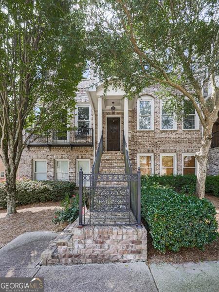 Priced below appraisal!! Quietly nestled in the convenience of Alpharetta, this custom end-unit townhome exudes luxury with it's high-end finishes and generous floor plan. Complete with hardwoods throughout, upgraded trim package, granite countertops, stained cabinets and more. The private dining room, gourmet kitchen, half bath and large family room are on the main floor with access to your private balcony overlooking a wooded area. Relax in the oversize owners' suite with a private sitting area, his and her walk in closets,fireplace and luxurious ensuite. Upstairs has 2 additional bedrooms, full bath and laundry. The lower floor is perfect for a home office, gym, or flex room with full bath. Close to local shops and restaurants, Avalon, Halycon and easy asses to GA-400 yet private enough to retreat from life's stresses. Hidden Forest is a gated community with swimming pool and dog park. If you are looking for a place to call home while still feeling connected, this is your new home!