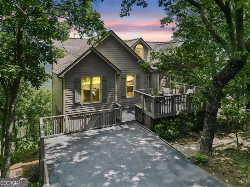 This beautifully appointed and updated 5 B/R - 3 Full Bath design home enjoys an open floorplan with long range unobstructed panoramic mountain views from every vantage point that are absolutely breathtaking. The interior mountain views are quite dramatic, and many proclaim them to be the best in all of Big Canoe. Large Master B/R Suite features a newly built walk-in shower and an enormous window that extends floor to ceiling, plus two additional spacious guest bedrooms and a 2nd full bath plus a small study/office, all located on the main level. Highly sought after wide plank hardwood flooring, cathedral ceiling with large picture windows and a stacked stone fireplace in the great room. The Kitchen has quartz countertops, large breakfast bar, wood cabinets, stainless steel appliances and pantry plus private dining room with panoramic views. Large family room with 2 more bedrooms and 1 full bath located on the terrace, plus an expansive laundry room and utility room for storage. Large outdoor dining area with cathedral ceiling, expansive open deck and level driveway on the main level. The asphalt shingle roof was replaced in 2024, the main level Hvac unit was replaced in 2025, and the terrace level unit was replaced in 2017. Ridgeview Drive is conveniently situated between the Big Canoe Clubhouse and Wolfscratch Village where the amenities are located, and for good measure is just 5 few minutes from the Main Gate for quick and easy access in and out of Big Canoe. A very special find, and won't be disappointed!