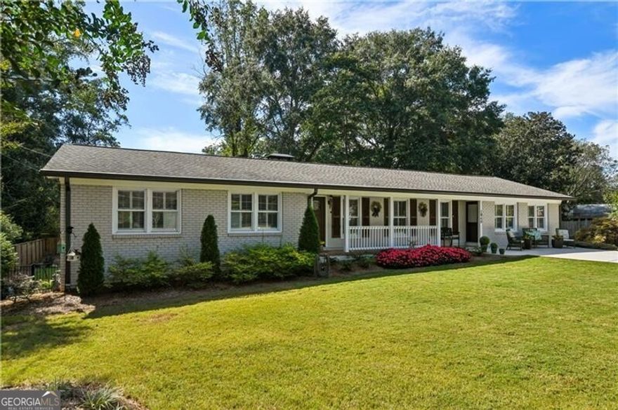 Welcome home to a true gem in the Garden District of Alpharetta, where this beautifully updated ranch home exudes charm throughout. Nestled on over half an acre, this residence is just walking distance from downtown Alpharetta, offering unparalleled convenience to the city's shops, farmer's markets, amphitheater, and restaurants. Minutes away, you'll find the Avalon, Wills Park, historic Crabapple, and the home is within the acclaimed Cambridge High School District. The exterior of this home radiates elegance with its freshly painted brick, well-maintained landscaping, a newer architectural roof, gutters, and a newly repaved concrete driveway. Enjoy serene evenings on your back porch or sunroom with panoramic views, tranquility, and privacy.  Inside the home, the open floor plan seamlessly connects to a fully remodeled kitchen, showcasing modern finishes, custom cabinetry, backsplash, custom-built bar, and upgraded stainless steel appliances. A spacious laundry room on the main level provides ample storage, blending functionality with style. The luxurious primary suite features a newly expanded and remodeled bathroom with a tiled walk-in shower and double vanities. The guest bathroom is equally stunning, with a contemporary walk-in tile shower. Recent updates extend to essential systems, including a HVAC, a full-house dehumidifier, a new water heater, and spray foam insulation, all under 3 years old. The basement and crawl space have been completely waterproofed and reinforced with additional support beams. The unfinished basement is equipped with central heating and air, ready for you to customize, envision, and make your own. This home offers a rare blend of modern luxury and historic charm in a prime location. Come tour this property that is beautiful as is or could easily be expanded for a growing family.