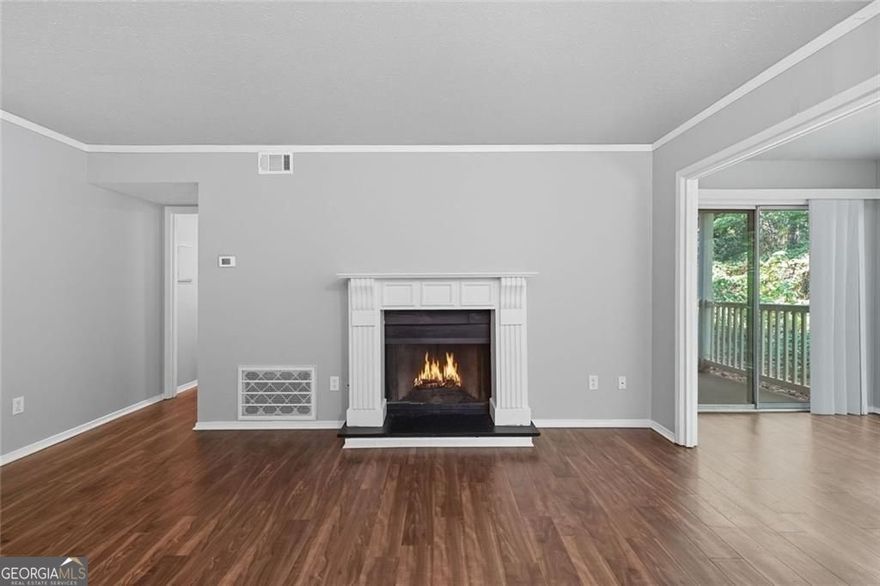 Live close to everything in this well-positioned Marietta condo-just minutes from Truist Park, The Battery, and a wide selection of shopping, dining, and entertainment. Public transit is within walking distance, and major roads nearby make commuting to Dobbins Air Force Base, Lockheed Martin, or downtown Atlanta straightforward.  Inside, the layout is smart and inviting. The living room gets beautiful natural light and features a fireplace as its focal point, opening directly into a fully enclosed sunroom. Whether you need a dedicated home office, a reading nook, or a space for your houseplants to thrive, this sun-filled area offers the flexibility.  The kitchen is crisp and updated with quartz countertops, newer cabinetry, and new flooring that continues throughout the home-no carpet, no hassle.  Both bedrooms are oversized and offer walk-in closets, with an extra storage closet in the second bedroom for added convenience. Two full bathrooms allow for privacy and ease, whether you're hosting guests or sharing the space.  The community offers unassigned parking, a pool, and clubhouse access. And with no rental restrictions, this unit works equally well as a personal home or investment property in a location that keeps you connected to both work and play.