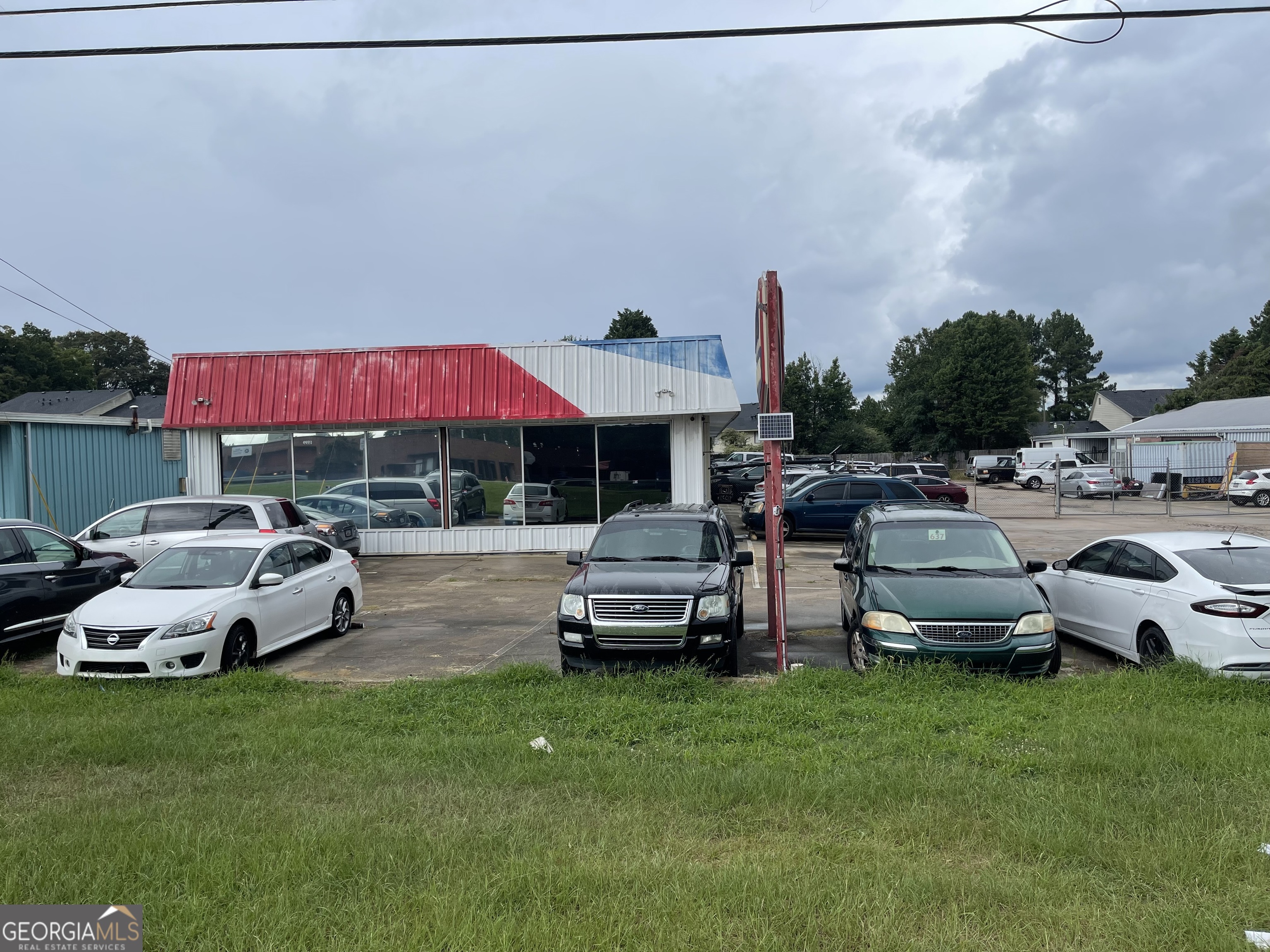Don't miss this rare opportunity to own a fully equipped automotive repair facility in a prime commercial location just minutes from Interstate 20 in the heart of Conyers, GA. This high-visibility property offers outstanding access and exposure, ideal for automotive professionals looking to expand or establish their business. With a tenant in place, you have instant income. Situated on a well-trafficked road with strong local and commuter visibility, this property features a spacious garage/workshop area, 6 service bays with roll-up doors, heavy-duty lifts, compressor systems, and a reception/waiting area for customers. There's also a private office, bathroom, and ample storage for tools and parts. The lot offers plenty of paved, and secured, parking for customer vehicles, work trucks, or inventory, with room for future expansion. The building is zoned commercial, and the layout is flexible enough to accommodate general auto repair, tire sales, or a specialty performance shop. Conveniently located near shopping, dining, and major transportation routes, this property is perfect for attracting local and regional customers. Adjacent property is for sale, also. Property ID is 0690010090.