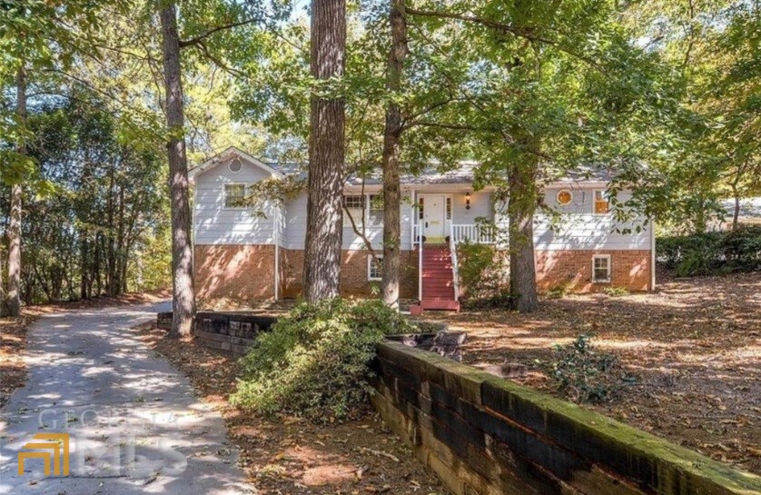 Don't miss out on this 4 Bedroom and 3.5 Bath home in the desirable Brookwood School District. You'll love the open Kitchen, Living room and beautiful hardwood floors. Fall in love with the huge Master suite, walk-in closet and beautiful fenced outdoor space to enjoy the private wooded lot. Set back from the street nestled in hardwoods. Property is convenient to Hwy 78, Five Forks Trickum, Stone Mtn Park and multiple shoppping centers. Don't miss this property!