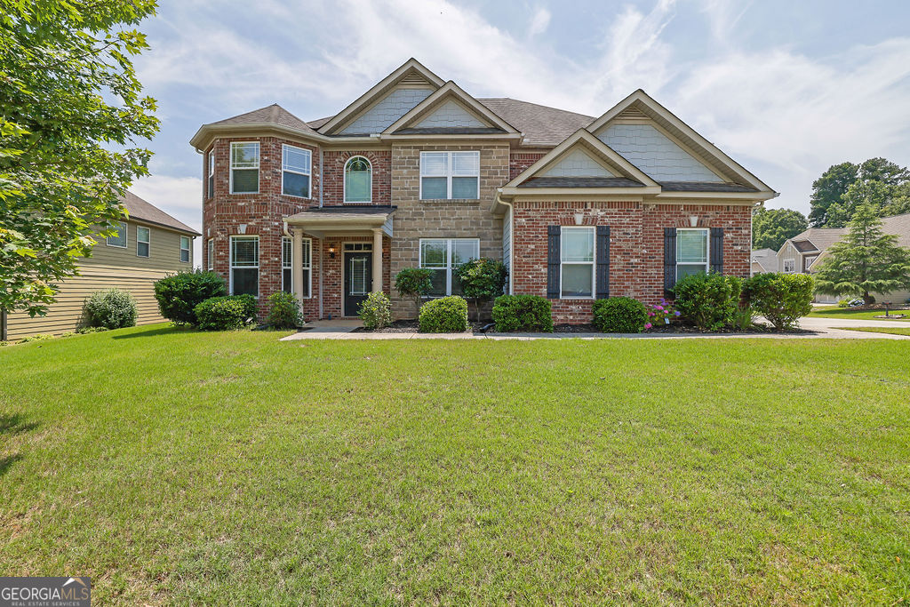 Welcome to this beautifully designed 5-bedroom, 4-bathroom home, where elegance, space, and functionality come together seamlessly. Situated on an oversized corner lot, this property offers privacy and abundant outdoor space. Step inside and be greeted by rich engineered hardwood floors that flow throughout the main level. The thoughtfully designed layout includes a formal dining room and a versatile office or additional living area. The gourmet kitchen is a chef's dream, featuring a brand-new refrigerator, double oven, gas stove, granite countertops, a spacious island, and a cozy eat-in area with bar seating-perfect for both everyday meals and entertaining. A guest bedroom and a full bath on the main floor add convenience for visitors or multi-generational living. Ascend on either of the two staircases to the upper level, where FOUR well-appointed bedrooms and three full baths await. One bedroom features its own en suite, offering added comfort and privacy. A separate staircase leads to the impressive primary suite, complete with a private den, his-and-her walk-in closets, and a spa-like bathroom featuring dual vanities, a soaking tub, and a separate shower for a luxurious retreat. Step outside from the family room to a covered patio overlooking a serene, private backyard-an ideal space for outdoor gatherings or peaceful relaxation. Additional features include an electric car charger in the garage and a state-of-the-art camera system with motion-activated detectors for added security. This exceptional home offers the perfect combination of modern convenience and timeless elegance. Don't miss your opportunity-schedule your private tour today!