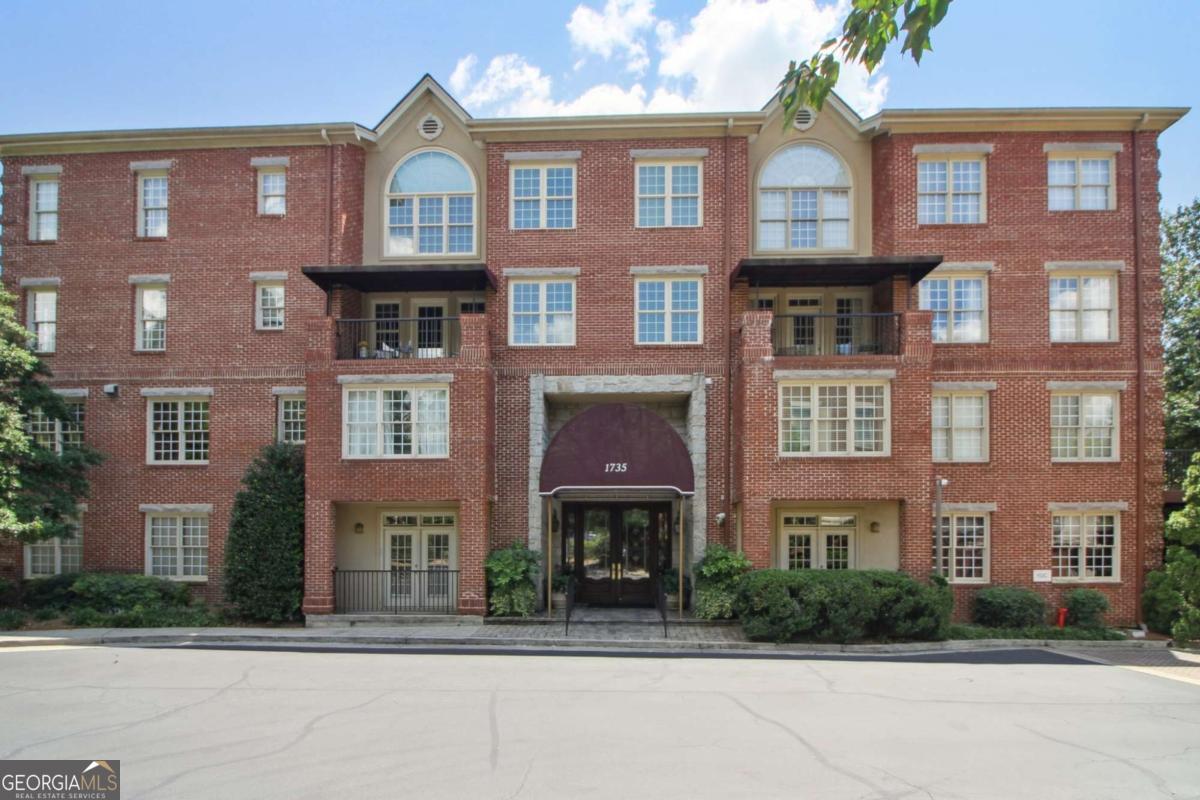 Truly a rare find! This stepless, first-floor 2 bed + 2 bath with a unique, expansive covered patio on the quiet side of the building is a special condo. Also included is a deeded storage unit (4x11) and 2 side-by-side garage parking spaces. The timeless floor plan features an entry foyer that opens to a separate formal dining room and spacious living room with a custom fireplace and a wall of windows. Beautiful kitchen with wood cabinets, granite counters, stainless steel appliances, and breakfast eat-in nook. Primary bedroom suite with walk-in closet, bathroom with soaking tub, separate shower, and double vanity. Secondary Bedroom with walk-in closet and large bathroom. New Paint, elegant molding, and hardwood floors throughout. Enjoy a peaceful, low-maintenance lifestyle with 24/7 concierge, secure gated access, and incredible amenities: clubroom, fitness center, theater, pool, grills, courtyard, and two dog runs-plus plenty of guest parking. HOA dues include gas, cable, internet, and trash/recycling. Located in one of Atlanta's best-kept secrets, with unbeatable access to the Beltline, Piedmont Park, Woodruff Arts Center, top dining, Piedmont Hospital, major highways, and more. Spacious, secure, and social-this is the lifestyle you've been looking for.
