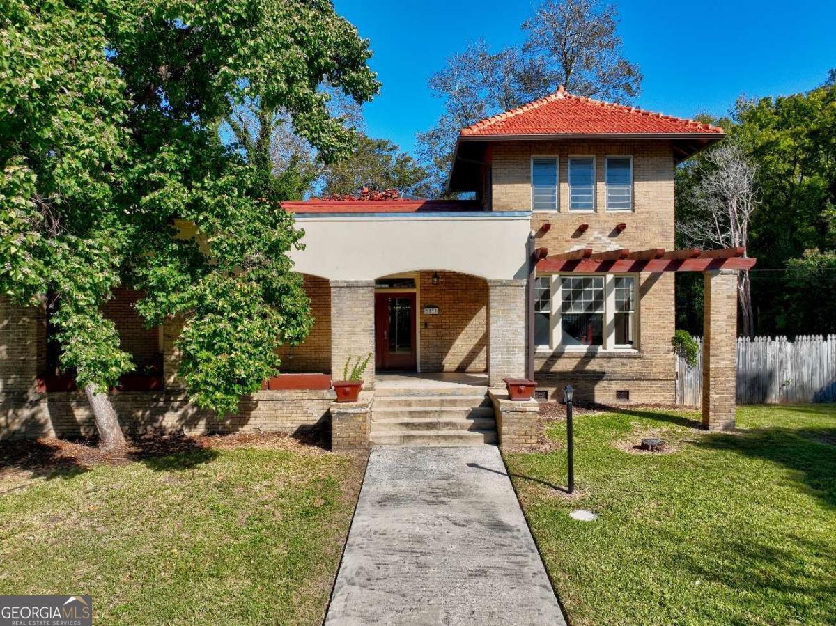 Welcome To 2733 Hillcrest Ave, Macon GA- The Historic & Unique Guy E Paine Home! Located In The National Registered Historic District Of Cherokee Heights. This Mediterranean Style House, Blending Italian And Spanish Architecture, Was Built Approximately In 1912. Offering A Secluded Feel And Well Protected From Street Noise, This Villa Is Perched On Two Lots Almost A Half Acre. As You Drive Up, You Are Greeted By The Striking Stucco and Brick Facade, Portico, Porte-Cochere, And Oversized 2-Car Garage In Rear, Hinting At The Luxury That Awaits Within. Stepping Through The Original Wood-Framed-Glass -Double Doors Into The Grand Room, You Are Immediately Warmed By The Refined Elegance. The Intricate Wood Beams Create A Sense Of Architectural Grandness, Inviting You To Gaze Upwards In Awe. At The Heart Of This Room, The Original Fireplace Adds A Touch Of Coziness And Creates A Focal Point That Exudes Comfort And Style. Natural Light Floods Into Every Room Courtesy Of The Generously Sized Original Wood Windows. The Grand Room Original Bi-Fold Wood -Framed -Glass Doors Lead Into A Must See Atrium With A Sun Lite Roof And A Towering Avocado Tree In The Center.. Blurring The Boundaries Between Interior And Exterior Spaces..This Is Truly One Of A Kind. Envision Afternoon Tea, Or Evening Gatherings As A Second Set Of Original Bi-Fold Wood-Frame-Glass Doors Lead Into The Adjacent Dining Room. With Its Close Proximity To The Kitchen Via The ButlerCOs Pantry The Flow Between Dining And Relaxation Is Seamless. The Architectural Layout Thoughtfully Divides Three Generous Size Bedrooms With Private Bathrooms On The Left And Right Side Of Atrium. An Additional Second-Floor Tower Bedroom Known As A Turret Offers A True Sanctuary Above The Private Library/Office. With Every Detail Meticulously Crafted To Evoke A Sense Of Luxury, Comfort And Sophistication In The Beginning Of The 20th Century, This Masterpiece Is Both Timeless And The Epitome Of Elegance Today In The 21st Century. Located 80 Minutes From The World's Busiest Airport-Hartsfield Jackson Atlanta International Airport; Within Ten Minutes To Downtown Macon; 15 Min To Ocmulgee Mounds National Historic Park; 10 Mins To Starbucks, The Fresh Market, Publix And So Much More. A Home That Should Be Viewed In Person To Truly Appreciate All That It Has To Offer. Call To Schedule A Private Showing! All Buyers Must Submit Pre-Approval Letter And Provide 48 Hour Notice For Private Showings. There Is No Lockbox On The Home. Listing Agent Will Be Present At All Showings.