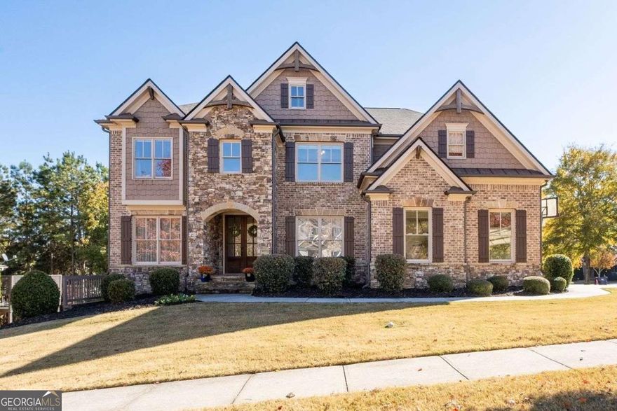 Freshly painted, Beautiful 6 Bedroom, 5 bathroom home in Waterside at Lanier Springs! Have you been looking for a home with more room? This home has everything you need and storage galore! Brand new roof just installed! Gorgeous curb appeal, you are welcomed home by the custom entryway. The entire main floor and upper floors have beautifully stained, real hardwood flooring. Carpet is in basement only. The formal dining room is a wonderful space for holidays! The front formal living room would also make a great home office or homework area. The main family room is open concept to the kitchen and eat-in dining area, which makes it a perfect space for family time together. Both the formal dining room and family room feature custom beamed ceilings, and all the custom trim detail can be found throughout the home! The kitchen is the heart of the home, with tons of cabinets, granite countertops, stainless steel appliances and large kitchen island! Right off the family room you can spend time on the fabulous screened-in porch. Main level features a generous sized guest bedroom and full bath. Upstairs has plenty of room with an oversized Owner's Suite, huge open loft/bonus room, guest bedroom with private ensuite bathroom, and two large bedrooms sharing a hall bathroom with double vanity. The Basement is open concept and full of potential! It can be used as an in-law suite, or as entertaining space. Basement features a full kitchen, guest bedroom, full bathroom, family room, and bar/game room! The backyard is fully fenced, private, and there is a full patio on the lower level. The driveway has been extended to allow for additional vehicle parking. The amenities for the community are wonderful and includes a pool with waterside, kiddie pool with mushroom, 4 tennis courts (pickleball courts), a playground, and a beautiful clubhouse used by Lanier Springs residents! Walking distance to White Oak Elementary and Lanier Middle schools. Right across the street from Lake Lanier and East Bank Park, and down the street from Gary Pirkle Park, it is an area surrounded by parks and activities! Easy access to downtown Sugar Hill and Downtown Buford!