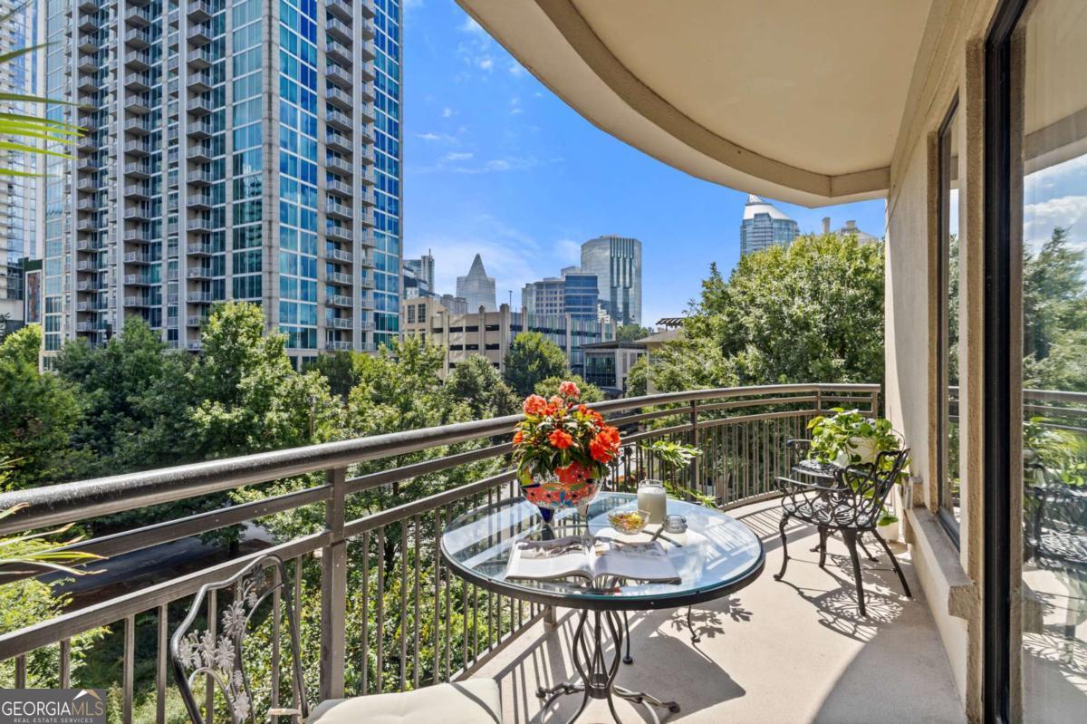 Welcome to sophisticated and luxurious living located in the prestigious Paramount at Buckhead condominium, in a completely renovated and spacious 1303 square foot home. Unwind on your expansive private balcony featuring stunning city skyline and treetop views, which are also visible from every window in this corner unit. The spacious open living concept has ten-foot ceilings, moldings, and many other custom features, and is perfect for entertaining in the massive living room. There is a designated dining room adjacent to the gourmet kitchen, which features high-end professional stainless appliances, quartz countertops and backsplash. Retreat to the primary bedroom and enjoy a walk-in closet that has been completely customized to showcase all your items as if you were in a boutique. The bathroom features a large dual vanity with Kohler fixtures and quartz countertop, with a large soaking tub and shower, and Toto toilet. The absolute highlight of this unit is a RARE, extra-large, 350 square feet (13.5'W x 25'L x 10'H) deeded private garage located in a prime location within the secure, gated, subterranean parking. This private garage provides extra storage and is the ultimate security for your prized vehicle. Experience the perfect blend of luxury and convenience at The Paramount at Buckhead, where every detail is thoughtfully curated for modern living. Amenities in the building include: Tennis Court; Pickleball Courts; Saltwater Pool; Cabanas with Televisions next to the Pool; Gym; Wine Tasting Room; Gourmet Kitchen and Lounge for Large Gatherings; Business Center with Three Private Meeting Rooms; 24/7 Concierge Services; Expansive Manicured Gardens with Fire Pit and Grilling Facilities; and a Private Screening Room. There is unique access behind the building to bypass the traffic on Peachtree Road to easily access Lenox Road and 400. The Paramount at Buckhead affords the best of city living as you can conveniently walk to restaurants, Lenox Mall, Phipps Plaza, Lifetime Fitness, and Marta. Award-winning restaurants such as Nobu, Mission and Market, Little Alley Steakhouse, South City Kitchen, Seven Lamps, and St. Cecilia are all within walking distance. The Marta Red Line Buckhead station entrance is literally across the street, for easy transport to the airport or downtown.
