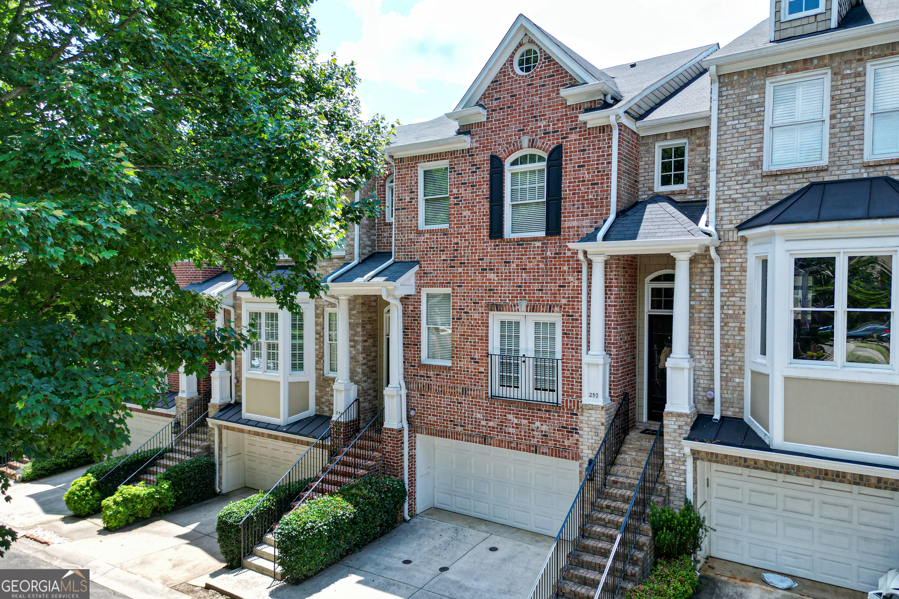 **Walking distance from Historic Marietta Square, this sought after gated townhome community offers a natural light filled ambiance with 10 ft high ceilings and engineered hardwood floors throughout the main floor living room. Sure to be a welcoming spot centered around beautiful fireplace. The open floor plan features a butler's bar & pantry w/ample storage & multiple 42 inch Kitchen cabinets, granite countertops and stainless steel appliances. Family room opens to Eat-In area with direct access to a covered patio. Retreat to your sanctuary, upstairs the oversize bedroom with 9 ft. tray ceiling and a huge walk-in closet offering plenty of storage for clothes and shoes. The lavish attached bath features dual vanities, jetted tub and oversize shower. Lower level offers stepless entry to a full finished basement Living/Game Room, with sizeable bedroom and fully updated bathroom. Excellent Marietta West Side school, this home is literally minutes from popular Marietta Square with numerous seasonal attractions, restaurants, shops and more. This prime location is perfect for medical professionals, who want access to Kennestone Hospital's District, downtown Atlanta via I75/285, Truist Park & the Battery, Cumberland Mall, miles of scenic trails in Kennesaw Mountain National Park. HOA dues cover gate, common area, exterior maintenance and sewer.