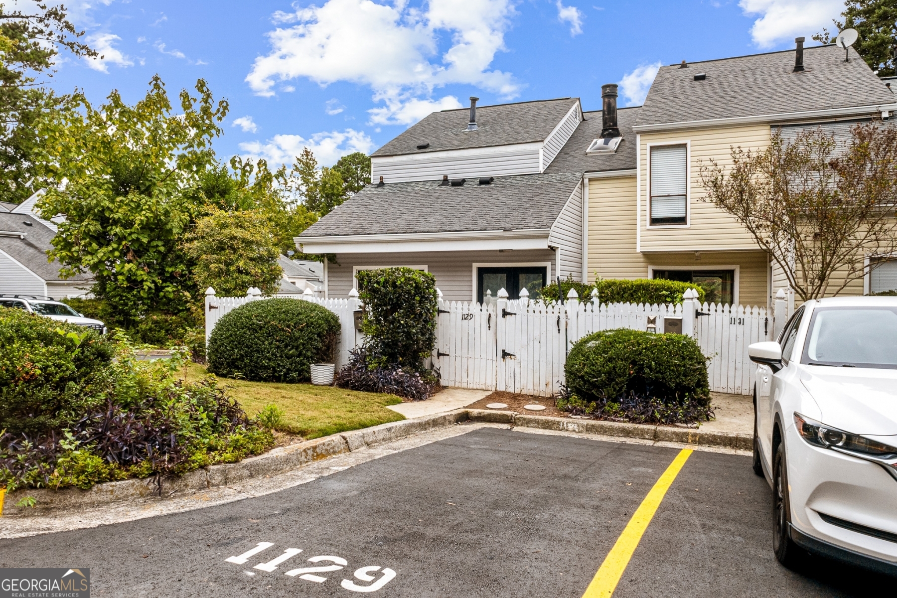 Stylish, move-in ready, End-Unit and minutes from everything Marietta! This updated townhome at 1129 Roselawn Lane features a sleek kitchen with stainless steel appliances, an open living area with tile floors, and a private fenced patio perfect for morning coffee or weekend BBQs. The large windows fill the space with light, while the cozy fireplace brings warmth and charm. Upstairs, you'll find spacious bedrooms and modern finishes throughout. Located just minutes from Marietta Square, Truist Park, and I-75, this home is perfect for anyone wanting comfort, convenience, and value all in one place.