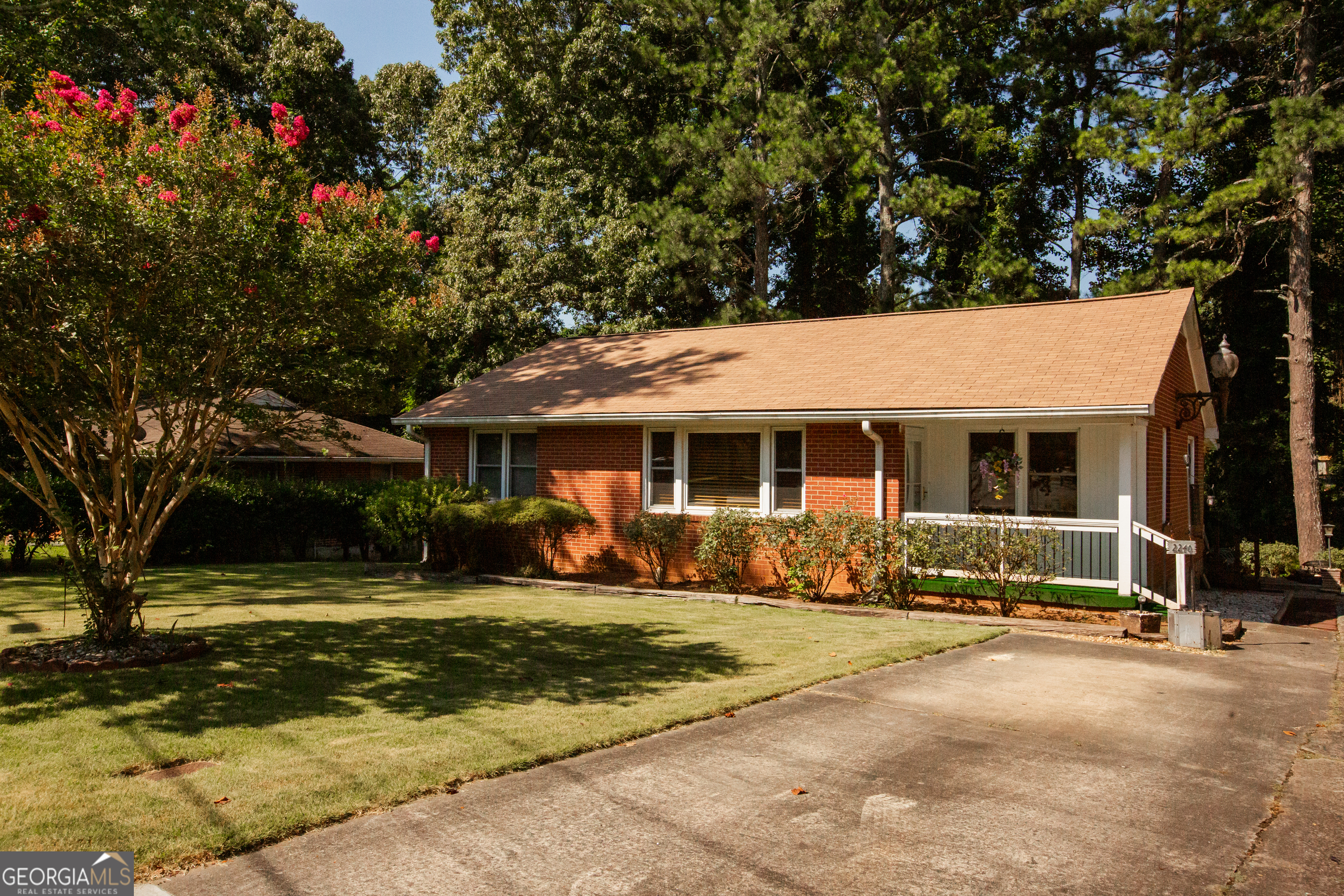 Charming 1950s Brick Ranch in Prime Smyrna Location! Welcome to this beautifully maintained 4-bedroom, 2-bath brick ranch, ideally located just minutes from The Battery, I-75, and I-285. Nestled in a quiet, established neighborhood with no HOA, this home offers timeless charm with modern updates. Step inside to find a spacious, light-filled layout featuring a large kitchen that opens to a cozy breakfast room and flows seamlessly into the adjoining dining room-perfect for everyday living and entertaining. The main level boasts two bedrooms with gorgeous hardwood floors and two with brand new carpet, all generously sized to suit your needs. The finished basement adds valuable flexible space-ideal for a media room, office, or playroom. Enjoy peace of mind with major system updates including a brand new roof, HVAC and hot water heater replaced in 2022, and a 10-year transferable HVAC warranty. Outside, relax on the peaceful back porch overlooking the beautifully landscaped yard, or take advantage of the oversized driveway with side-by-side parking. The home features an exterior light that was once one of the original street lights on the Marietta Square! This move-in ready home offers the perfect blend of location, space, and updates. Don't miss your chance to own a classic home in one of Smyrna's most convenient and desirable areas!