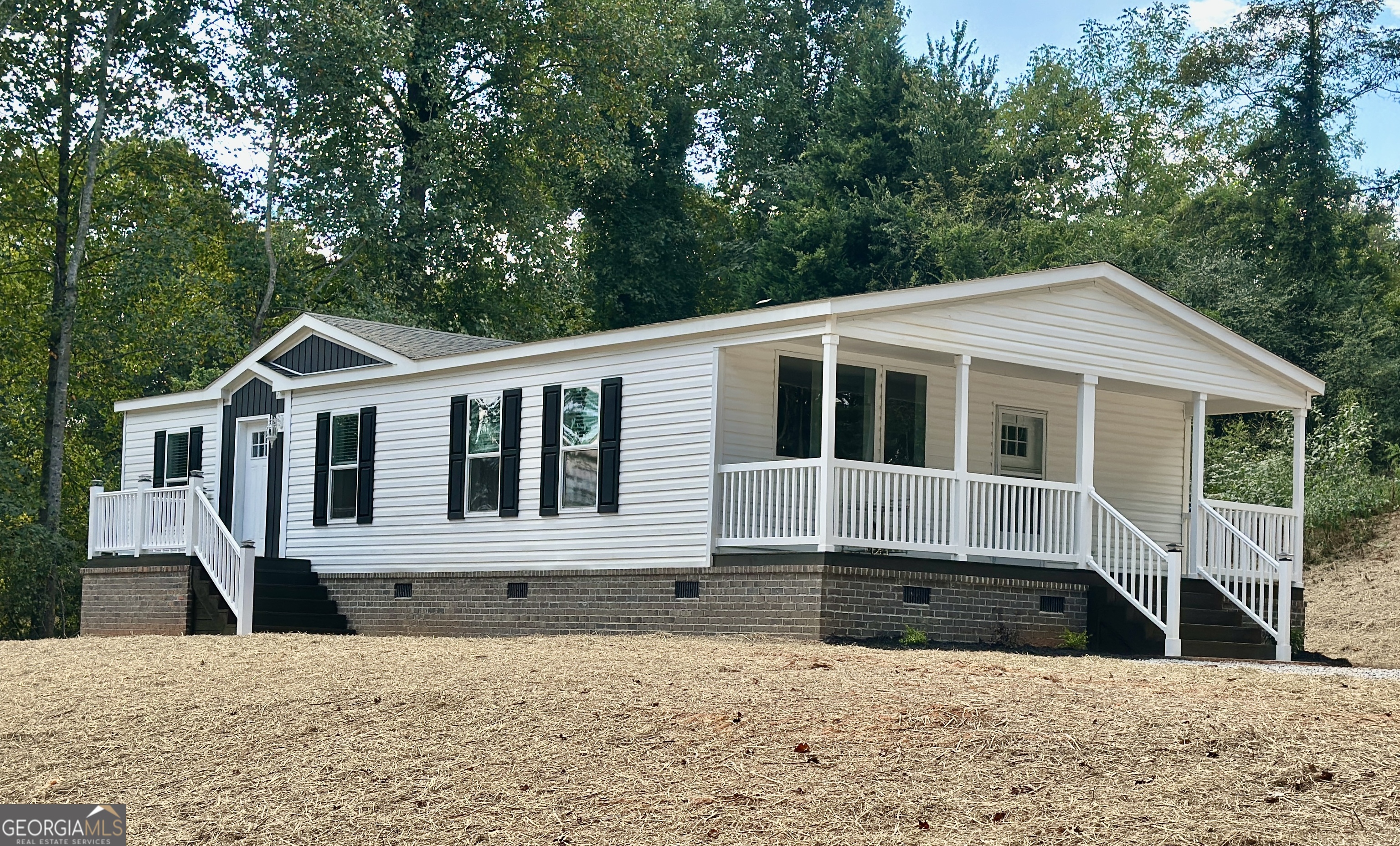 Another unique offering from Progressive Homes (PH); a premier land-home developer of Manufactured Homes in North Georgia- "Where Ordinary becomes Extraordinary. This brand new fully sheet-rocked 3 bedroom, 2 bath home has an open floor plan and a mud room with an area for an office space which opens to a beautiful, covered side porch. It includes an all-brick permanent foundation, a heat pump, OSB wrapped exterior, upgraded insulation, energy efficient windows, stainless-steel appliances, a remote-controlled electric fireplace, a programmable thermostat. No expense was spared to provide a truly unique enhanced low-cost quality living experience. All Progressive Homes lots are graded to maximum use of your land, capture the best views, and provide for adding a garage or workshop where possible. This home meets all FHA, VA, and Conventional Finance Standards and includes a 1-year house warranty. See the attached pictures to view the details that distinguish a Progressive Home from others. See Plat, home is located on Lot 1. Tax records reflect the land only as home was not placed on property until 2025.