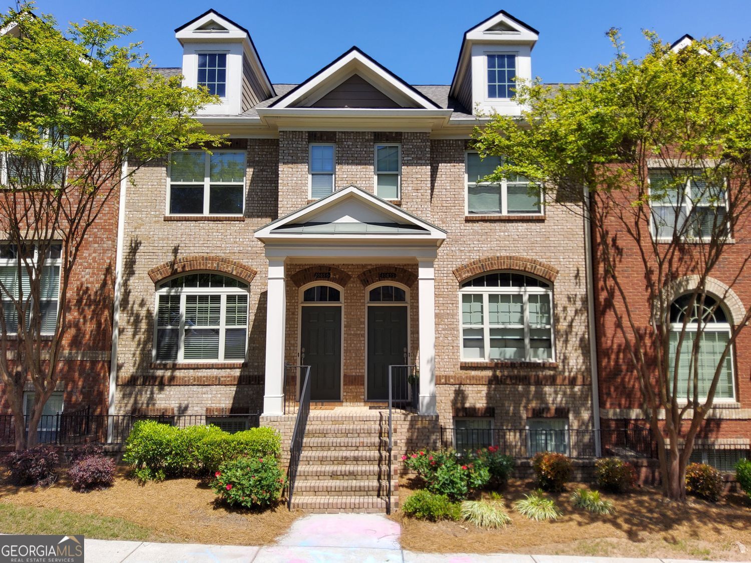 This stunning 3-bedroom, 3.5-bathroom townhome is ideally located in one of the Atlanta Metro area's most highly sought-after communities with access to top-rated schools. This beautifully maintained home features an open and inviting floor plan, accented by gorgeous hardwood flooring on the main level and a cozy fireplace that adds warmth and charm. Each bedroom has a private bathroom. The chef's kitchen is a true centerpiece, offering granite countertops, tile backsplash, rich wood cabinetry, a farmhouse sink, recessed lighting, stainless steel appliances, and a breakfast bar perfect for casual dining or entertaining guests. Custom-built-in bookshelves enhance the spacious living area with both style and function. A convenient sun room that can be used as a mini office nook provides a quiet space for remote work or study. Upstairs, the light-filled primary suite offers a peaceful retreat, complete with a spa-like ensuite bathroom. All full baths feature elegant ceramic tile flooring for a polished finish. Enjoy the wood deck, perfect for relaxing or entertaining. Additional highlights include ample storage space. Situated in a secure gated community with swim and tennis amenities, residents enjoy a low-maintenance, resort-style lifestyle with easy access to premier shopping, dining, parks, and major highways. This is a rare opportunity to own a home where luxury, comfort, and convenience come together. Schedule your private showing today!