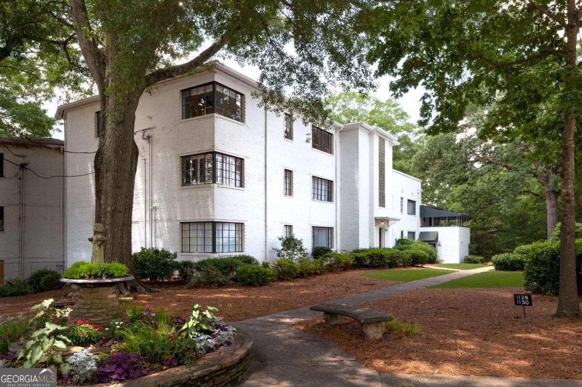 Top floor 2 bedroom unit in historic Briar Hills Condominiums. If you like light you will love this unit. Briar Hills was built in 1947 in the Mid-Century modern style with white brick exteriors, large windows, glass block accentuated entry halls, and flat roofs. Located between VA Highlands and Druid Hills the neighborhood is part of the Druid Hills Historic District. The complex consists of a mix of 2 and 3 bedroom condos and townhouses. As you enter the unit you experience the huge living room glowing with natural light. The separate dining room also with amazing windows then leads to the large kitchen with access to the roof and back stairs. From the living room you head toward the bedrooms through a short hall with a bath featuring original tilework. The primary bedroom is huge with a private fireplace and large window set overlooking the landscaped property. The primary bathroom has a tub/shower and period correct sink. Adjacent to the primary bedroom is the second bedroom with corner window set for tons of muted light filtered by the large oaks on the property. This a rare opportunity to live in a true historic environment with so much space and natural light. Located close to Emory, CDC and VA Highland shops and restaurants.