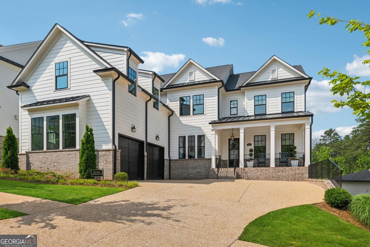 An exquisite residence that truly stands out-better than new and beautifully designed. Nestled in the prestigious Hillandale community, just minutes from Historic Downtown Roswell and offering a rare combination of classic elegance blended with contemporary style, this rare basement home features an open concept layout with upgraded finishes. Gracing one of the larger and most coveted lots in the community, the expansive backyard presents an opportunity for elevated outdoor living-perfectly suited for daily enjoyment, entertaining, or creating your own custom pool retreat. From the charming rocking chair front porch to clean traditional lines, columns, and elegant gas lanterns, the exterior invitation sets the tone for what lies within. Inside, you'll find an open, light-filled floorplan that flows effortlessly from foyer to study, dining room to casual living. The heart of the home is the gourmet kitchen, a chef's dream complete with a large island breakfast bar, natural stone countertops, stainless steel appliances-including double ovens, a gas cooktop, and refrigerator-as well as ceiling-height cabinetry, a spacious walk-in pantry, and powder room. A thoughtfully designed mudroom connects the kitchen to the garage, offering everyday practicality with style. Just off the kitchen, an enclosed patio to indulge year round. Retreat to the luxurious owner's suite, a serene haven featuring a massive walk-in closet, a true spa-inspired bath with dual vanities, soaking tub, and frameless glass shower. Every detail has been curated for ultimate comfort and relaxation. Additional highlights include a main-level guest suite with a private ensuite bath, and a versatile loft upstairs-perfect for a media room, home office, gym, or playroom. Rich white oak hardwood flooring extends throughout the main living areas, adding warmth and sophistication. The unfinished daylight terrace level is stubbed and ready to be transformed to suit your vision-whether it's a home theater, wine cellar, or additional living space. Don't miss this rare opportunity to own a truly remarkable home in one of Roswell's most desirable communities.