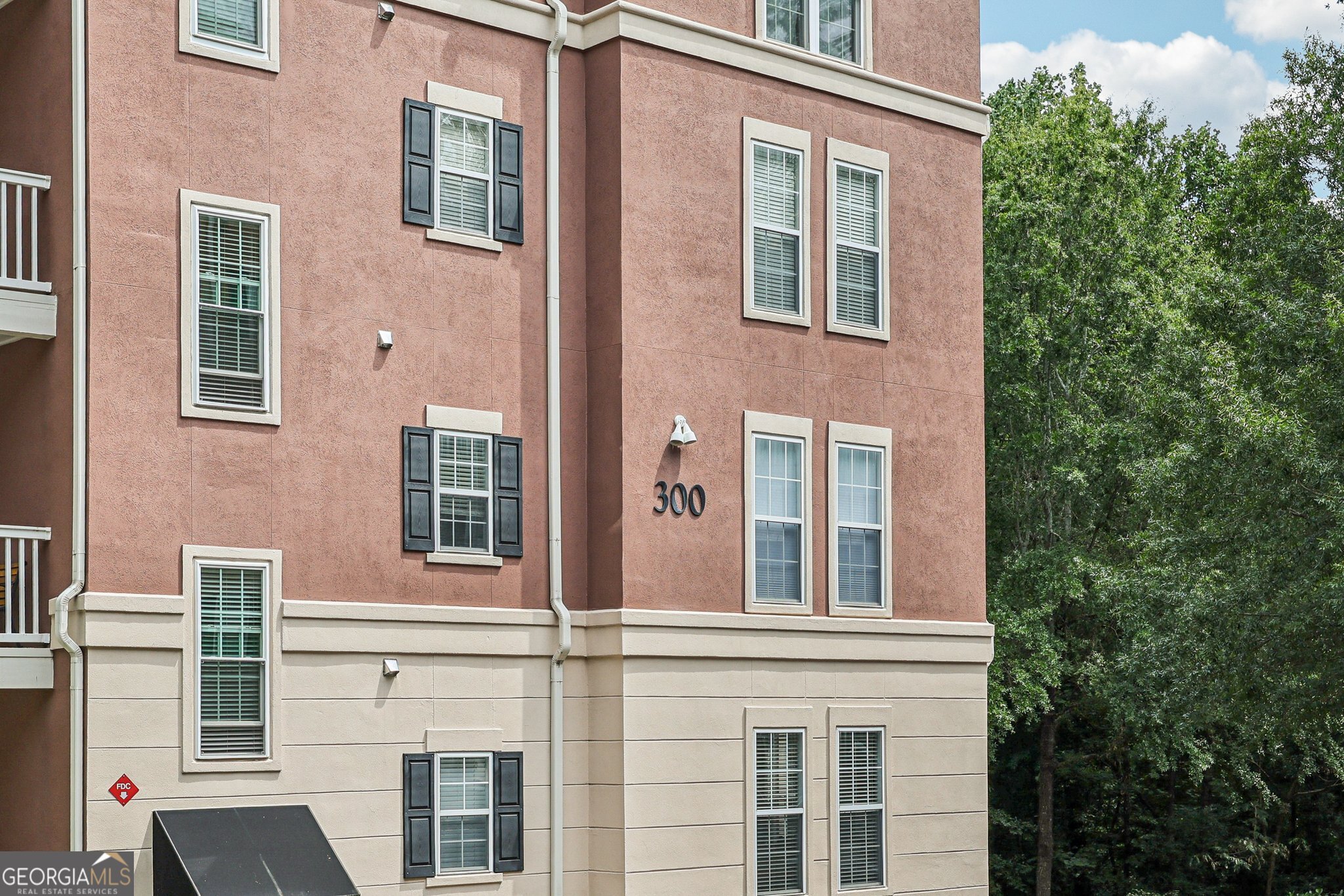 Welcome to this stunning 2-bedroom, 2-bath end-unit condo in a highly sought-after gated Dunwoody community! This third-floor home offers a bright, open layout featuring a kitchen with stainless steel appliances, granite countertops, and a breakfast bar overlooking the spacious living room. Each bedroom has its own en suite bath and large walk-in closet, providing comfort and privacy. Enjoy peaceful wooded views and a private balcony. This home also includes a deeded parking space and a spacious storage room for added convenience. Community amenities include a saltwater pool, fitness center, and secure access. Conveniently located near Perimeter Mall, Dunwoody Village, and I-285, this condo combines style, comfort, and unbeatable location!