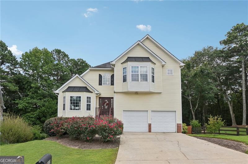 Welcome to 402 Towne Valley Drive, located one mile from Downtown Woodstock. This stunning 4-bedroom, 3.5-bathroom home perfectly blends comfort, function, and style. From the moment you enter, the two-story foyer and great room fill the space with natural sunlight, creating an open and inviting feel. The spacious primary suite offers a luxurious bathroom with a separate shower and soaking tub, while three additional bedrooms provide plenty of space for family, guests, or a home office. The finished basement is a highlight, complete with its own bedroom, full bathroom, kitchenette, and separate living room, along with a private entryway that makes it ideal for an in-law suite, guest quarters, or rental potential. Outdoor living shines with a large backyard featuring a cozy fire pit, a beautiful porch overlooking the yard, and a concrete patio, perfect for relaxing or entertaining. A 2-car garage offers ample parking and storage, while the location in the heart of Woodstock provides convenient access to local parks, shopping, dining, and top-rated schools. Minutes from highway 575.