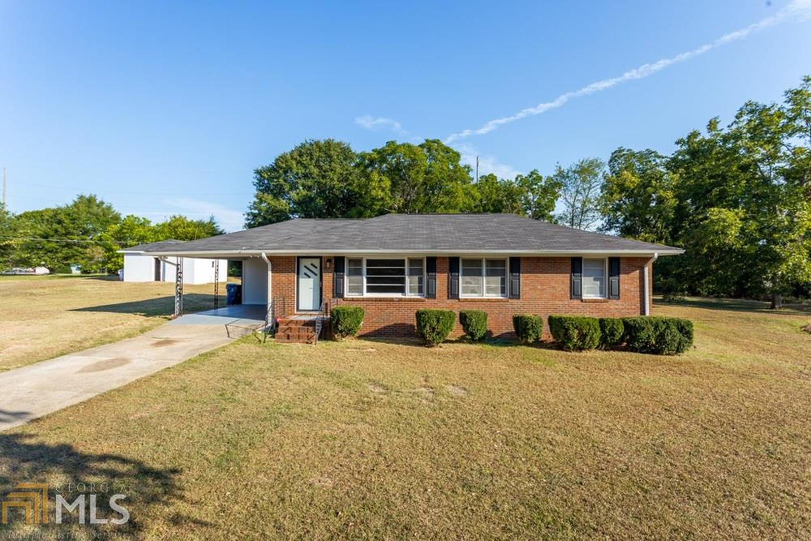 Great renovation on this 3-bedroom, 1.5 bath, four- sided brick home. Fresh, beautiful light gray paint with white trim. Beautifully refinished, original hardwoods. Newly painted kitchen cabinets with new pulls and new countertop, Nearly new Roof, HVAC and water heater. New gutters and soffit. New tub/shower, new toilets. Totally resurfaced baths. Walk to downtown McDonough shopping and restaurants from this great convenient location. This gem will not last.