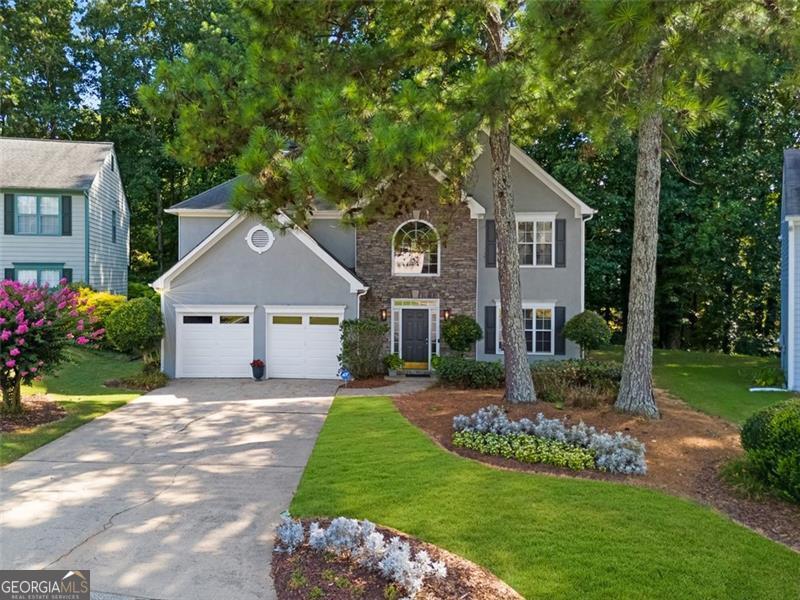 Welcome to this beautifully maintained, one-owner home that's ready for its next chapter! Nestled in a friendly cul-de-sac, the home boasts a charming stacked stone and stucco exterior, with HardiPlank siding (2022), fresh exterior paint (2022), and new garage doors (2022), ensuring great curb appeal. Step inside to find fresh interior paint throughout, durable LVP flooring on the main level, and brand-new carpet in the owner's suite, upstairs hallway, and staircase. The spacious owner's suite shines with a just-updated spa-like bathroom (July 2025), featuring new tile floors, quartz countertops, cabinets, mirrors, lighting, faucets, and a beautifully renovated shower. Other recent updates include a new water heater (2023) and a freshly painted owner's bedroom and closet. The open family room with soaring ceilings is perfect for entertaining, while the kitchen offers new quartz countertops and a window view of the serene backyard-a true retreat for bird lovers. Conveniently located near Sprayberry High School, shopping, dining, gyms, and major highways, this home truly has it all. Don't miss your chance to make it yours!