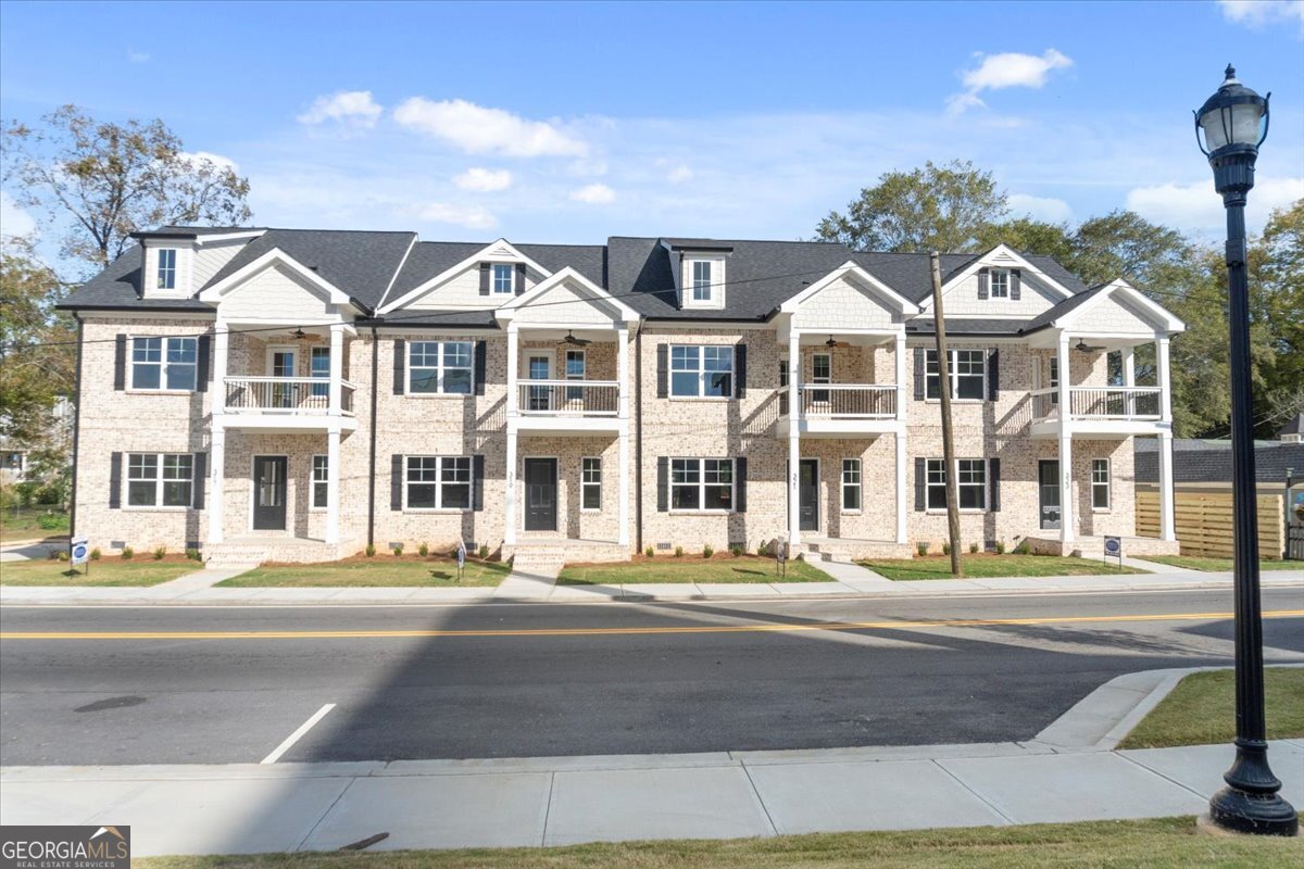 Downtown Living New Construction. Presenting The Overlook of Monroe, a rare downtown 4 Bedroom Upscale Townhome opportunity where concerts, festivals, vibrant shopping and dining are just outside your front door. These 4-sided Brick, stylish & modern new construction 2-story Townhomes are beautifully detailed with numerous upgrades. Discover the charm of this inviting, thoughtfully designed open concept that seamlessly blends the Living Room, Dining area, Bar Nook and Kitchen to create the ideal layout for entertaining. The large Foyer is inviting and includes two separate areas to design and create as you choose along with a Coat Closet and Powder Room. Relax in the Living Room around the Modern, Electric Fireplace with a Custom Built Mantle. The Kitchen is sure to impress with Quartz Countertops, Subway Tile Backsplash, Custom Built, Soft-Close Cabinets, a Barn-Style 1/2 Glass Pantry Door and Stainless Steel Appliances. There is Recessed Lighting throughout and Tile Flooring and Granite Countertops in all the Bathrooms. The Owner's Suite is conveniently located on the main floor and boasts a Full Bath with a Walk-in Tiled Shower with Frameless Glass Door and Rain Showerhead. There is also a Walk-in Primary Closet with Double Shelving to accomodate lots of clothes. The upper level includes 3 additional Bedrooms with Double Shelving Closets to maximize space, a Tiled Bathroom and a Tiled Laundry Room. There is also a large attic space for additional storage. These downtown Townhomes provide a low maintenance brick exterior with 3 separate covered areas to enjoy the outdoors including the Front Porch, an open-air Back Porch and oversized Balcony to entertain friends while overlooking the Town Green and concerts. Experience a lifestyle of comfort and convenience in these beautifully appointed townhomes. Total SF including Covered Porches is 2,016. Townhomes include 1 Year Builder Warranty for peace of mind. There are currently 2 units available inlcuding 1 Traditional Style Finishes (Cabinets, Doors, Flooring, Lighting) and 1 Modern Style Finishes. Both styles exude upscale, modern downtown living.