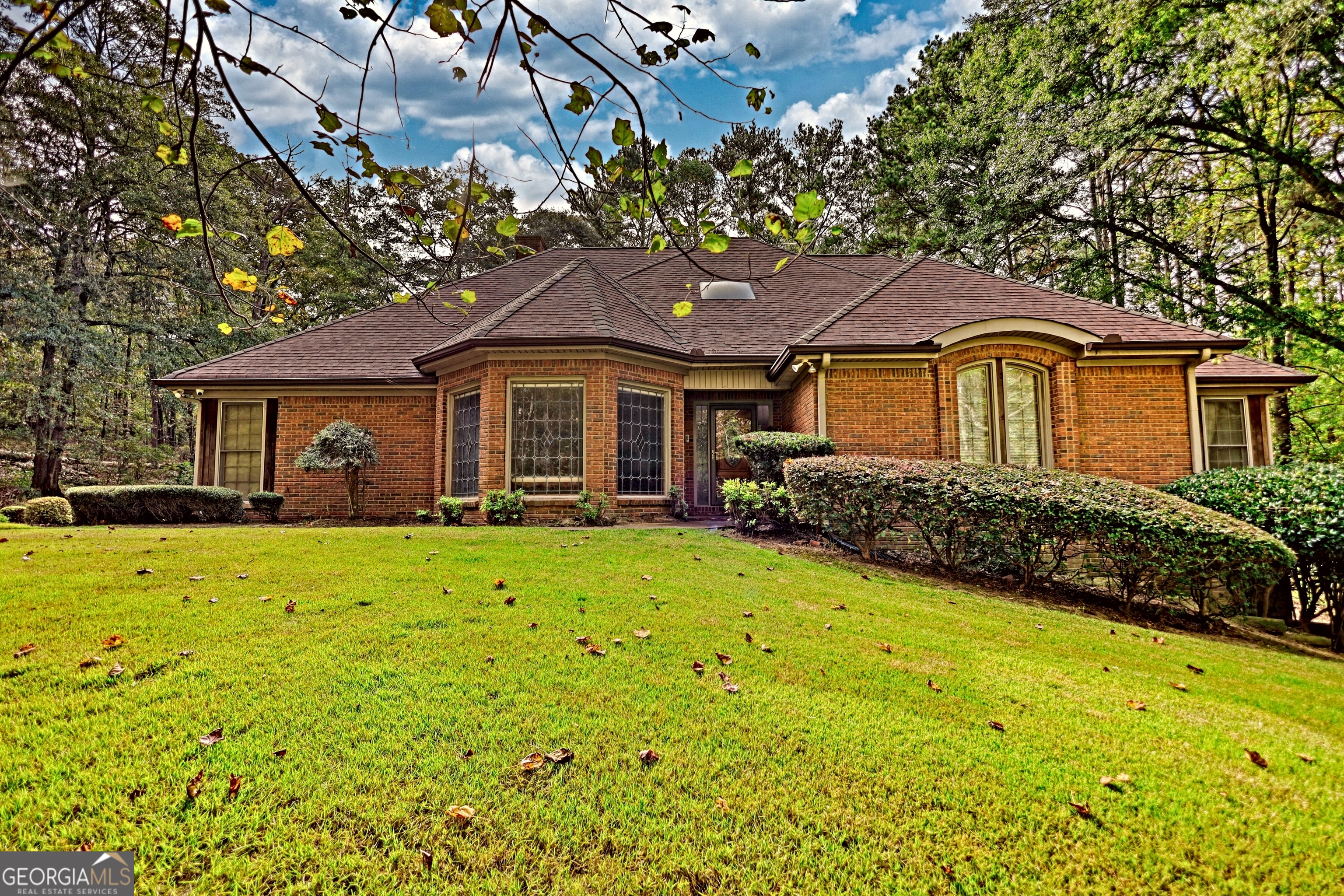 Beautifully landscaped and lighted winding driveway leads you to this all Brick ranch on a basement with 5 acres! This is a great home that has 4 bedrooms and 3 full baths. The family room has a masonry fireplace and opens to the sun porch, which is great for enjoying your plants and some warm sun! There is a formal dining room as well as an eat-in area in the kitchen, which has ample cabinetry and a pantry for extra storage. The guest bedroom and bath opens to the hallway from dining and family room. The primary suite has a tray ceiling and its own private bath with a garden tub and shower with his and her vanities. The home has a 2-car side entry garage, full unfinished basement and a gorgeous wooded 5 acre lot. Loaded with upgraded trim, custom features including a wet bar area off the family room, true cedar closet in the basement as well as a finished office, there is even a walk up attic off the hall and primary suite. There are beautiful Crepe Myrtle trees and Junipers that line the street and driveway, blueberry bushes off the basement entry and a wooded lot that brings privacy and beauty. The home has a full house intercom/music system, the dining room has full length etched glass windows that bring in natural light. The home with a little personalization and updates will be a dream home!