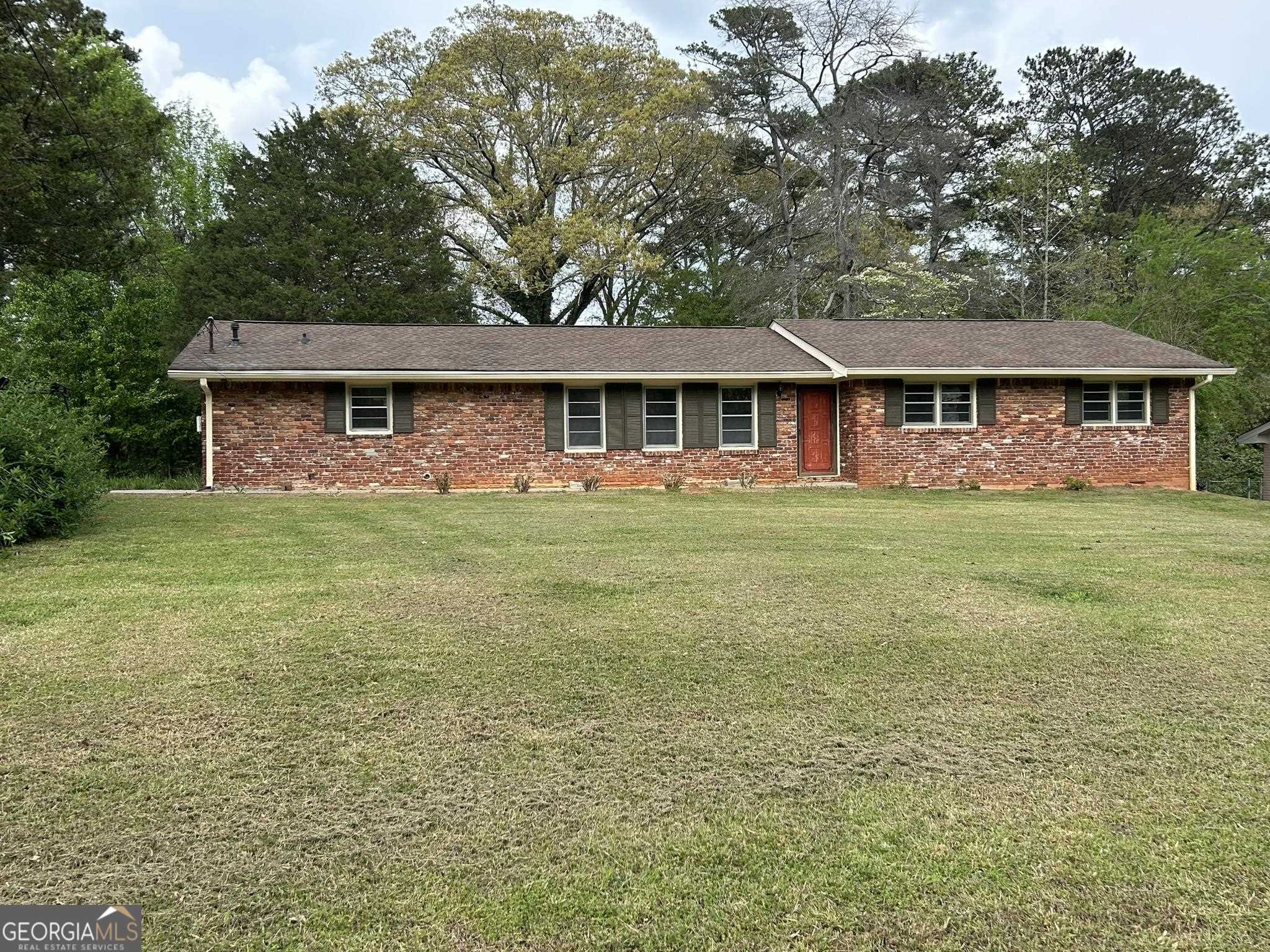JUST LIKE NEW! Landlord just finishing up doing a total remodel on this 3 bedroom/2 bath home with large outbuilding. Large open floorplan with fireplace. Brand new kitchen cabinets, new stainless-steel appliances and quartz countertops. Freshly finished hardwood floors throughout. Large laundry room gives lots of storage or pantry space in addition to plenty of room for laundry. Both bathrooms completely redone from top to bottom - new tile, new lighting, new vanities. Updated ceiling fans and lighting throughout the home. Large flat yard gives plenty of play space or room for gardening. Home is close to schools and shopping. Parkview cluster schools - Camp Creek Elementary, Trickum Middle, Parkview High. Great parks nearby for your enjoyment. Be the first in line to get this jewel of a home! No pets allowed in this rental.