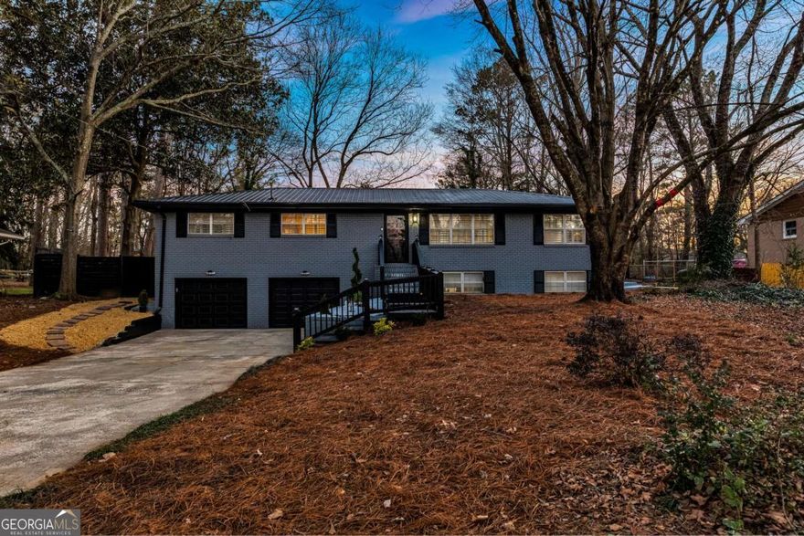 This timeless beauty is ready for you to move right in! Welcome to this beautifully renovated 4 bed / 3 bath home where modern luxury meets timeless design. Every detail has been carefully considered, with high-end finishes and upgrades throughout. Recent improvements include a 2024 HVAC system, new water heater, updated electrical panel, interior plumbing, and waterproof LVP flooring. Plantation shutters, crown molding, and refinished/new hardwoods add character, while abundant natural light enhances the inviting atmosphere. The main level offers a seamless flow, starting with a dining room at the entrance leading into the open-concept living room and chef's kitchen. The kitchen is a true centerpiece, featuring stainless steel appliances, granite countertops with a waterfall edge, a breakfast bar, and sleek white cabinetry. Adjacent to the kitchen, the updated mudroom includes a laundry area, cabinets, and a counter space for added convenience. The primary suite features his and hers closets and a beautifully updated ensuite bathroom. Two additional main-level bedrooms share a thoughtfully renovated bathroom with modern finishes. Downstairs, the finished basement features beamed ceilings, a spacious living area perfect for entertaining, a bedroom, and a full bathroom. Step outside to your private retreat in the expansive fenced backyard. The brand-new deck, complete with a grill, fire pit area, and hot tub, is ideal for relaxation. The newly added gazebo, featuring an island, offers a wonderful space for hosting gatherings, while outdoor bistro lighting adds a warm, inviting ambiance. Additional upgrades include a metal roof, concrete perimeter around the home, upgraded drainage, and a freshly painted garage. This home is a rare find - don't miss the opportunity to make it yours!