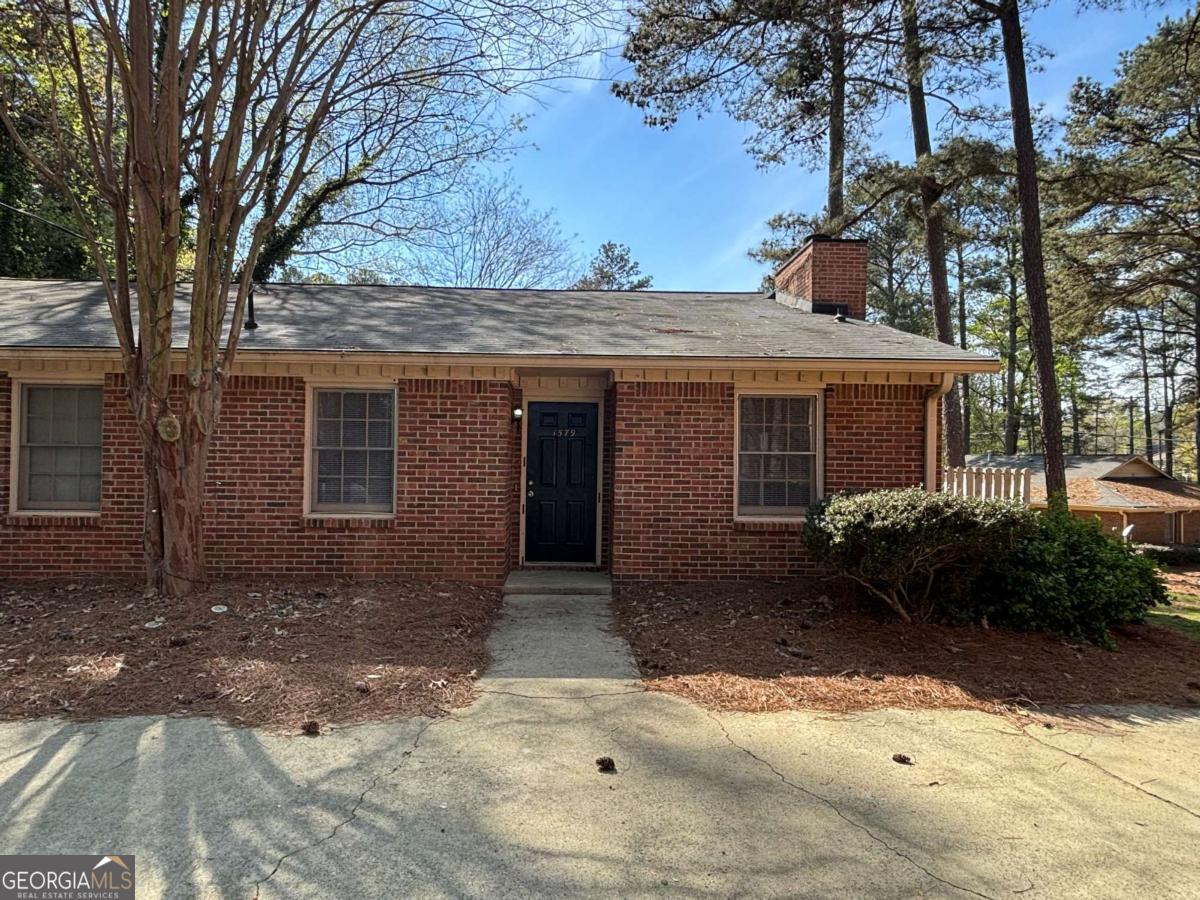 Conveniently located near I-85 and Jimmy Carter Blvd., this spacious and well-maintained brick duplex offers comfort, functionality, and easy access to everything you need. Step inside to discover an open-concept living and dining area filled with natural light, featuring a cozy brick fireplace and stylish LVP flooring throughout the main living spaces. The kitchen is equipped with classic white cabinetry, an electric range, refrigerator, dishwasher, and a laundry closet with full-size washer and dryer hookups for your convenience. Both bedrooms are carpeted for comfort and offer walk-in closets and easy access to bathrooms with tub/shower combos and large vanities. Enjoy quiet moments or entertain outdoors on your private back patio with a semi-privacy fence-perfect for relaxing afternoons or weekend gatherings. WE NEVER ADVERTISE ON CRAIGSLIST OR FACEBOOK MARKETPLACE.
