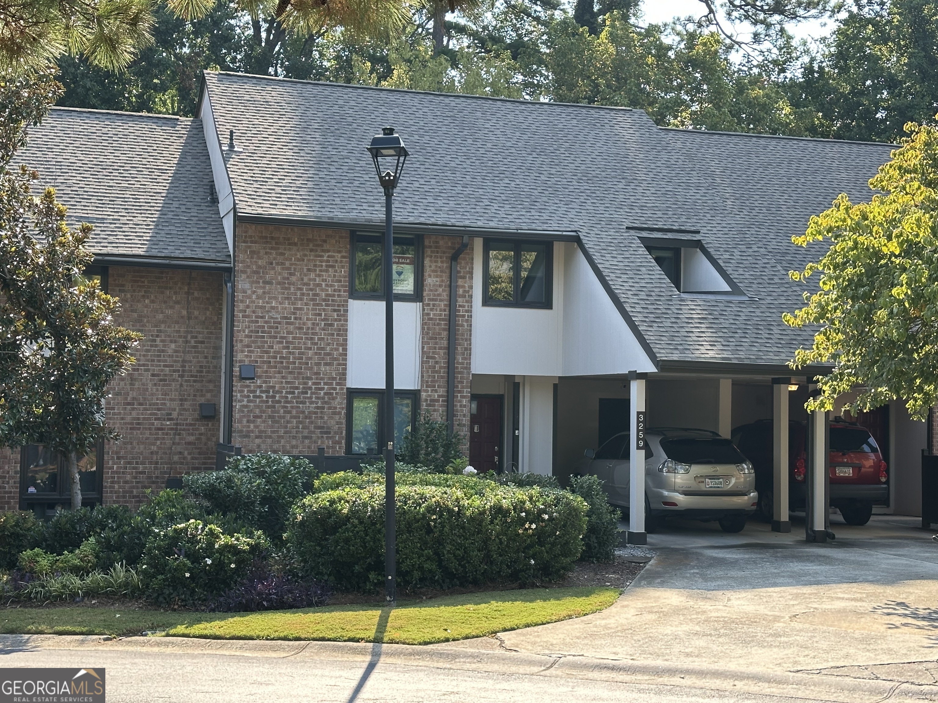Step into this architecturally distinct 70s modern townhome, where mid-century design meets contemporary comfort. Featuring a dramatic two-story great room with soaring ceilings, a cozy fireplace, and hardwood floors, this home exudes both character and warmth. With three spacious bedrooms and 2.5 bathrooms, this thoughtfully designed home offers an ideal layout for both relaxation and entertaining. The primary suite boasts a spacious private balcony with lush wooded views, perfect for morning coffee or evening unwinding. Downstairs, a private courtyard provides a serene retreat, surrounded by nature for added privacy and tranquility. Recent updates include all-new Anderson windows and newer heating and air system, ensuring efficiency and year-round comfort. This unit also features a covered carport and an additional assigned parking space for your second vehicle. Nestled in a beautifully maintained community, you'll enjoy access to a large swimming pool, tennis court, and professionally landscaped grounds. Plus, with brand-new roofs and exterior siding recently completed, this community is both stylish and well-maintained. Don't miss this rare opportunity to own a piece of 70s modern architectural charm with modern upgrades and scenic outdoor spaces. Schedule your private tour today!