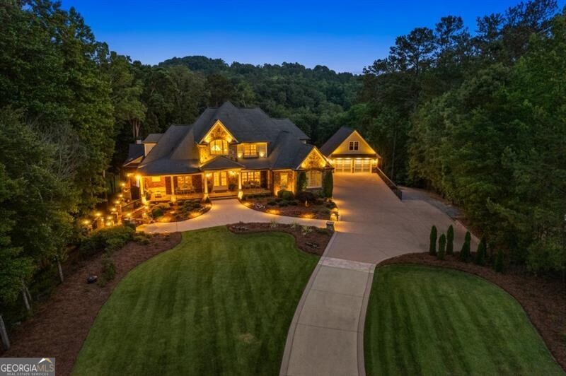 There are places that seem to exist beyond time... where nature whispers, light dances across stone, and every moment feels both effortless and extraordinary. This is one of those rare places." This home is close to everything, yet nestled within the gated community enclave, "The Retreat at Pumpkinvine Estates." It's an exceptional 6.3-acre estate gracefully set more than 500 feet beyond its private approach, backing to the tranquil beauty of Pumpkinvine Creek! The setting is of pure serenity - deer gazing in the meadows, sunsets across lush landscapes, and starlit evenings enhanced by softly lit stone pillars and an immersive soundscape. This home features, Solid Brick, Chiseled Stone, and Board and Batten Exteriors, L-Shaped Stone Front Porch. Inside, a soaring Two-Story Foyer welcomes you with light-stained hardwoods, custom plantation shutters, refined millwork, and elegant lighting throughout. The heart of the home is an entertainer's dream: a gourmet kitchen with brand-new Thermador appliances, a Wolf undermount Microwave Drawer. Custom Two-Toned Knotted Cherry Wood Cabinetry. The kitchen opens into into a cozy den, that features a dramatic oversized fireplace with beautiful granite seating, flanked by two beautiful custom built-ins. The main-level oversized primary suite offers a private haven with sitting area, spa bath, and dressing room and oversized shower with jets. The second level has three oversized ensuite bedrooms that provide luxury and comfort for family and guest. The expansive terrace level offers unmatched flexibility for more bedrooms, fitness, media area, living spaces and abundant storage and more. The Outdoor Living Space is extraordinary: a grand pavilion with multiple luxury granite/stacked travertine bars, and a sound system that surrounds the Egyptian style swimming pool, and a 16 seating oversized spa. Unforgettable ambiance after dark, making this "The Ultimate Retreat!