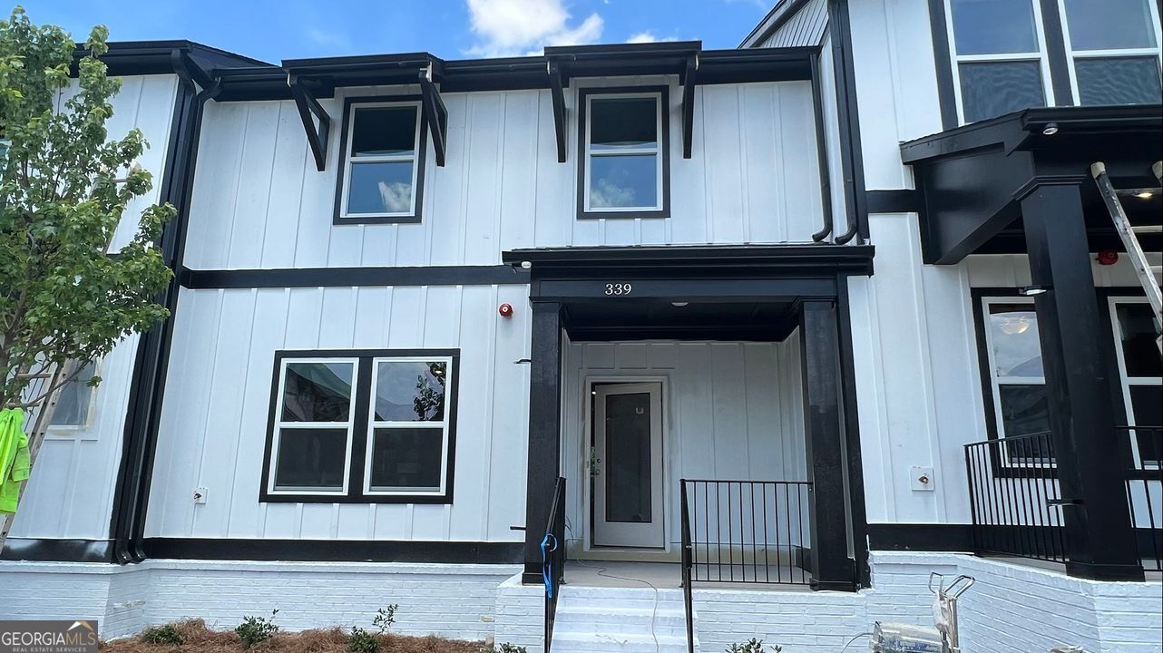 Welcome to this stunning 3-story townhome in the sought-after Ridgewalk Landing community, located in the highly rated Woodstock High School District. Boasting 4 spacious bedrooms and 3.5 baths, this stylish residence offers a perfect blend of functionality, comfort, and contemporary design. The main level features an open-concept layout with hardwood floors throughout, seamlessly connecting the chef-inspired kitchen to the light-filled living area. Enjoy quartz countertops, a large island with bar seating, gas cooktop, double wall ovens, and stainless steel appliances-perfect for entertaining or everyday living. The lower level includes a versatile bedroom with a full bath, ideal for a home office, gym, or guest suite. Upstairs, you'll find three additional bedrooms, including a luxurious primary suite with a walk-in closet and a spa-like en-suite bath, plus a convenient laundry room on the same floor. Step outside to enjoy front and back decks, perfect for your morning coffee or evening unwind. The 2-car garage with opener adds extra convenience, while the community amenities-including a swimming pool and walking trails-enhance the vibrant lifestyle. Unbeatable location just north of Downtown Woodstock, WALK TO COSTCO, The Outlet Shoppes, shops, and restaurants, and with easy access to I-575 and the new express lane. Plus, you're just minutes from Rope Mill Park-a paradise for biking, hiking, kayaking, and nature lovers alike! Apply today and ready live in most desirable communities in Woodstock!