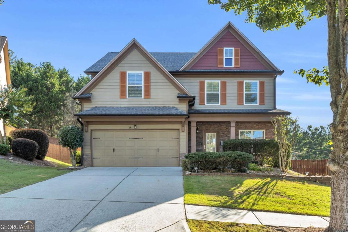 Welcome to 6126 Barker Landing in Sugar Hill, GA! This beautifully maintained home offers an open-concept layout filled with natural light, featuring vaulted ceilings, a spacious family room, and a modern kitchen with granite countertops, stainless steel appliances, and a large island. The main-level owner's suite boasts a spa-like bathroom with dual vanities and a walk-in closet, while additional bedrooms upstairs provide flexibility for guests, office space, or a growing family. Enjoy outdoor living with a covered back porch and a private, landscaped yard perfect for relaxing or entertaining. Located in a quiet, friendly neighborhood just minutes from top-rated schools, Gary Pirkle Park, shopping, and major highways-this home combines comfort, style, and convenience in one perfect package.