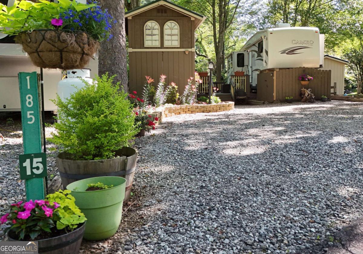 Tucked away in a peaceful, well-kept park, this beautifully landscaped RV lot offers the perfect mountain escape! Overlooking a fast-flowing creek, this fully furnished 1-bedroom, 1-bath RV is move-in ready. Enjoy the sounds of rushing water, mountain views, and a lush outdoor setting. Just minutes from Vogel State Park, Brasstown Bald, and Helton Falls, it's ideal for nature lovers. With short and long-term rentals allowed, this property also makes a fantastic investment. Low yearly fees cover water, sewer, trash, and yard maintenance-easy living with all the charm! Call me today!