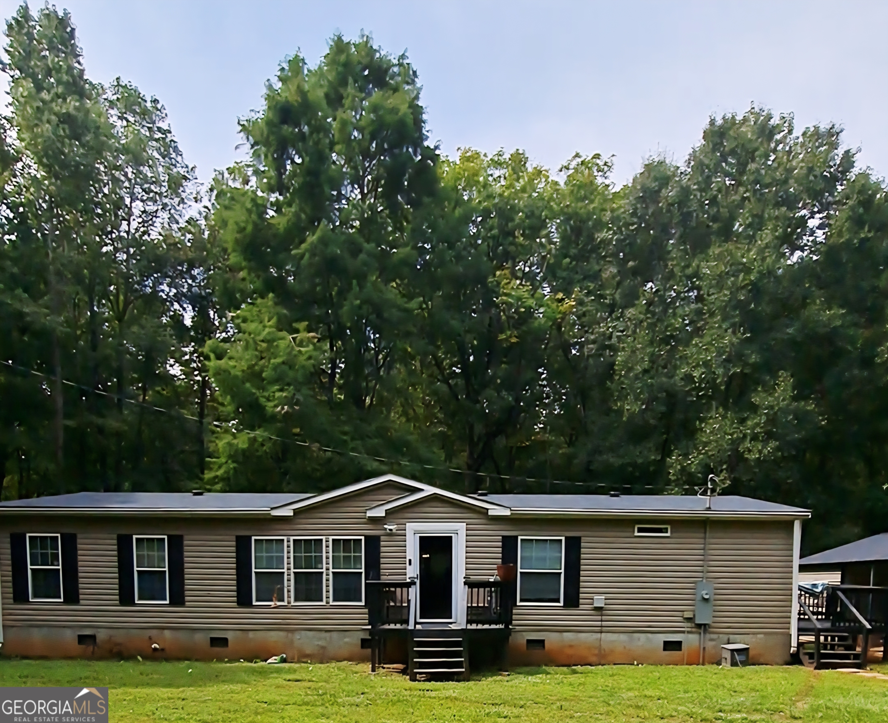 Welcome Home! This home offers plenty opportunities to create your dream landscape with privacy you can't buy in the city and suburbs. You'll be 10 minutes from Georgia State University Newton Campus and from I-20. About 10 minutes outside of Covington, GA this spacious 4 bedroom 2 full baths manufactured home rests on .82 acres located in beautiful historic Newborn, GA. Carpeted bedrooms, Huge walk-in closet, separate tub and shower in Primary bedroom. kitchen with an island. Including a large pavilion for your outdoor gatherings, 2 car-carport with attached storage.