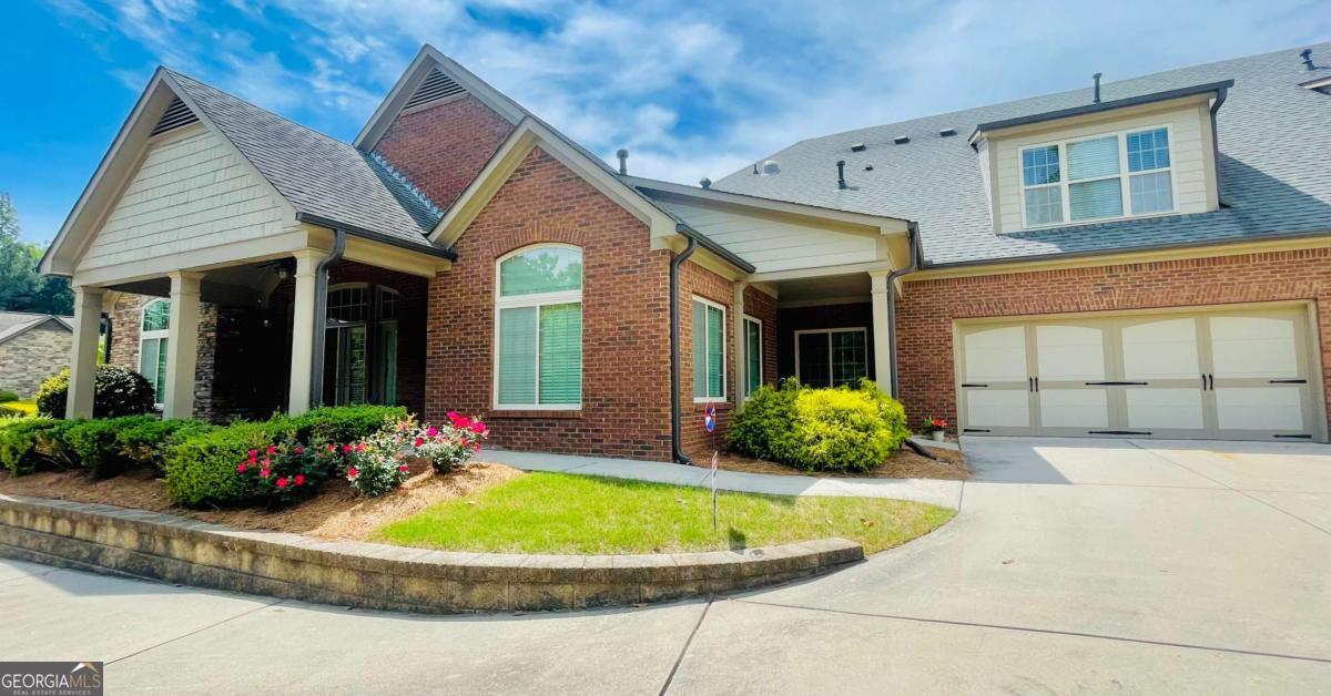 MOTIVATED SELLER is offering $10,000 to Buyer that can be used for Closing Costs, Price Reduction, etc for accepted contract signed before September 30, 2025, and closing no later than October 30, 2025. Welcome to your private retreat in the heart of Forsyth County. This exceptional 4-bedroom, 3-bath residence is set within an exclusive 55+ gated community, offering the perfect blend of sophistication, comfort, and convenience. Step inside to find an elegant foyer opening into a bright and inviting living room, where a cozy fireplace is framed by custom built-in cabinetry. Hardwood floors flow seamlessly throughout the main level, guiding you into the expansive gourmet kitchen. Here, granite countertops, premium stainless-steel appliances, abundant cabinetry, and a pantry create a chef's dream space. The dining room, highlighted by soaring vaulted ceilings and walls of natural light, sets the stage for memorable gatherings. A private sitting room or home office adds flexibility, while the covered porch offers a tranquil escape-ideal for quiet mornings or evening entertaining. The luxurious primary suite features a spa-inspired shower with safety features already in place with dual vanities and a walk-in closet designed for effortless organization. Thoughtful touches, such as a built-in safe and hidden ironing board, enhance the home's refined appeal. Upstairs, a spacious bonus room with a full bath provides endless options for a media room, guest retreat, or hobby space. Completing this residence is a two-car garage with ample storage. Perfectly positioned near Cumming, Buford, Alpharetta, GA 400, Northside Hospital, shopping, dining, and Lake Lanier, this home delivers unmatched convenience with the serenity of a gated, low-maintenance lifestyle.