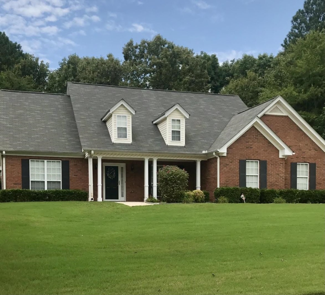 Look No Further! This charming ranch home, located in a swim and tennis subdivision, shows off its' rocking chair front porch, which is definitely, "Move In Ready!" Standing in the foyer entrance you'll notice beautiful hardwood floors that flow throughout the home. This open floor plan begins in the Great Room which includes a brick veneer fireplace and hearth, vaulted ceilings, and lots of natural light. The attractive columns in the formal dining room are inviting and bring a touch of elegance. The kitchen includes granite countertops, granite backsplash, matching granite breakfast bar, stainless steel appliances, walk-in pantry and a separate breakfast area. The Oversized Owners Suite includes double tray ceilings, recessed lighting and two walk-in closets with motion sensor lights. Also, the Owners bath has double vanities, Garden tub with an overhead heat light and a separate shower area. This is a Split bedroom plan with roomy secondary bedrooms and a full bath. Separate laundry room plus an upstairs Bonus room with attic access. Private level lot and an outbuilding for your extra storage needs.