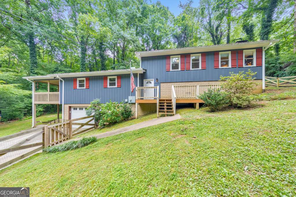 Back on market due to no fault of seller! SELLER IS OFFERING $10K TOWARDS BUYERS CLOSING COSTS! Supreme Lending is offering a $5,000 buyer credit towards closing costs! Welcome home to this lovely 3 bedroom, 2 bathroom split-level gem in the heart of Woodstock! A charming front porch welcomes you into an open concept main level featuring a fireside family room, dining area, and kitchen complete with an island, breakfast bar, and sunny breakfast room-perfect for everyday living and entertaining. The well-appointed primary suite offers a private retreat with an ensuite bathroom and direct access to a covered side deck with serene wooded views. Two generously sized secondary bedrooms share a full hall bathroom. Enjoy the outdoors on the additional rear covered deck and the large fenced front and side yard-ideal for pets, play, or gardening. This home also includes an attached 1-car garage and no HOA, offering freedom and flexibility for how you use your property. Located in the sought-after Woodstock High School district and less than 2 miles from vibrant Downtown Woodstock, where you'll find an abundance of shops, restaurants, and entertainment. With easy access to I-575, this home combines comfort, convenience, and charm in one perfect package!