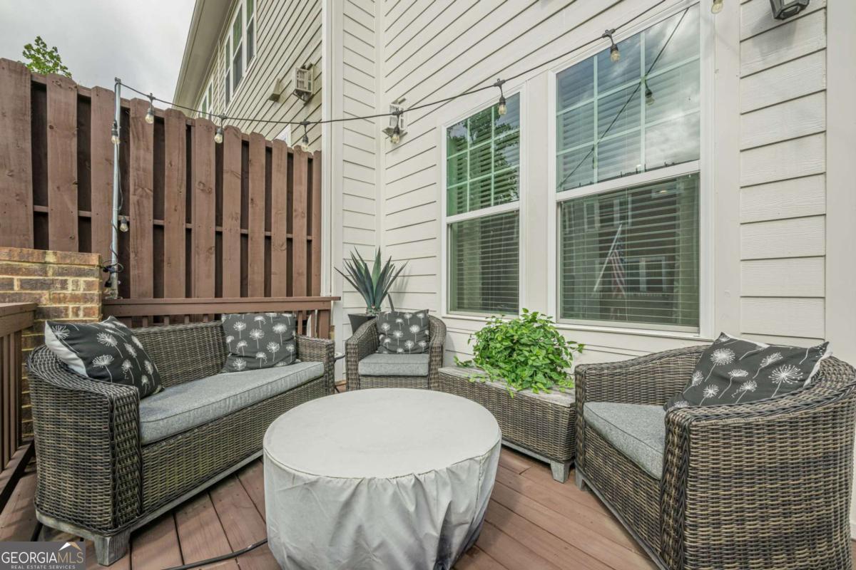 MUST SEE This immaculate, Move-in-Ready Townhome Conveniently located in the Heart of Alpharetta with easy access to Northpoint Mall, Avalon, Marriott, and all the best shopping, restaurants & schools nearby. You're going to love the elegant & inviting modern design. Step into the stylish layout of the bright & airy MAIN LEVEL with its soaring ceilings but stay cozy with the gas-started fireplace in main living area - Step out onto the balcony for even more entertaining potential. The gourmet eat-in, open-concept, chef's inspired kitchen features gorgeous, oversized island & breakfast bar, sleek, stainless-steel appliances, a fridge that stays, plenty of white cabinets & ample granite counter workspace, dual ovens, and butler's pantry. UPSTAIRS you have the primary ensuite featuring dual vanities, classy custom shower with glass doors, a bench seat, walk-in-closet & private toilet. There is also a spacious secondary bedroom with full hall bath, a laundry room, and attic access for more storage space with disappearing stairs. Plus, a sizable loft which could easily be converted into another bedroom if desired. Downstairs you have a media bonus room or even potential future bedroom with a half bath, coat closet, 2 car garage & 2 car driveway for extra guest parking. The local Community Offers a Pool, Excellent top-rated schools, plus Alpharetta's thriving amenities & active lifestyles like - dynamic shopping, fine dining, parks, and convenient access to major tech companies, all nearby. Ask about buyer's incentives and TOUR TODAY Before it Gets Away!