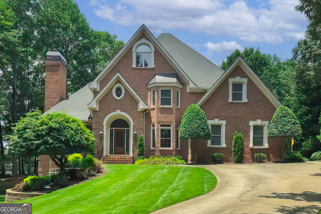 Gorgeous Brick home overlooking the 18th hole in Prestigous Golf Community! Retreat to exceptional Privacy in this beatifully maintained custom-built home nestled within one of Hall County's most desirable Golf Communities. Surrounded by mature oaks, the shaded drive leads to a residence that has been Lovingly maintained for over 25 years. Designed with craftsmanship and attention to detail, this home offers finishes and character rarely found in today's new construction. Inside enjoy a spacious layout featuring a main-level Owner's suite, custom finishes throughout, and a fully finished basement - perfect for entertaining or just relaxing. Step outside to a private deck overlooking the 18th hole, offering sereneviews and peaceful moments any time of day. Whether you're a golf enthusiast or simply seeking tranquility, this property is a must-see!!!