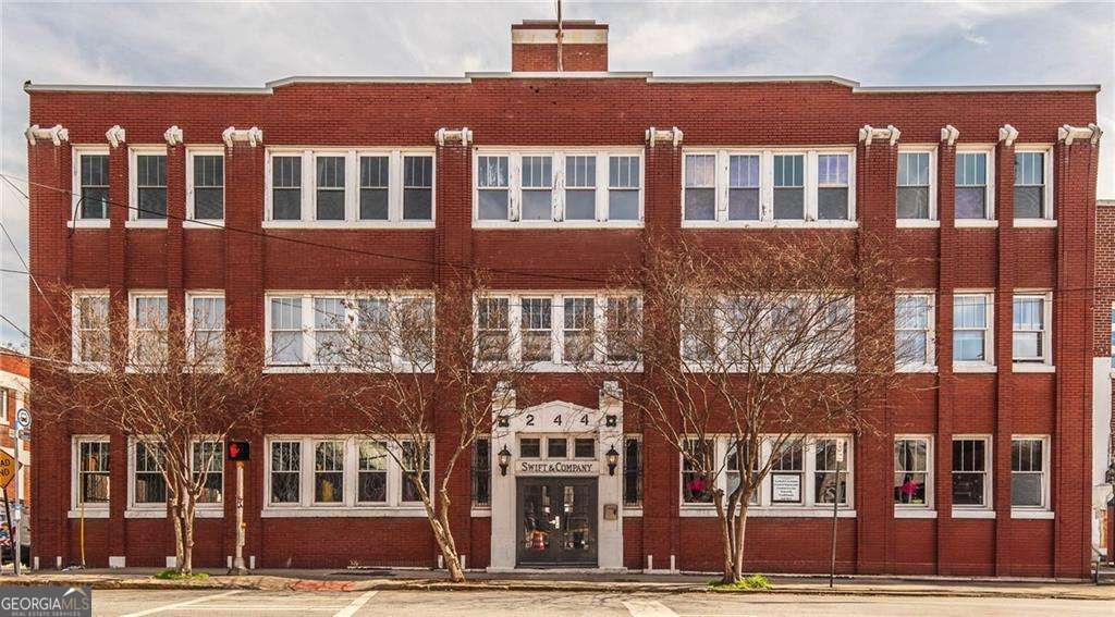 Experience the vibrant energy of Historic Castleberry Hill in this stunning 1,900 sq. ft. condo, perfectly located within walking distance of Mercedes-Benz Stadium, State Farm Arena, and Atlanta's best downtown attractions! The open-concept floor plan is perfect for cooking, entertaining, and gathering with friends, offering a seamless flow to your private outdoor deck complete with a dedicated grilling area and fenced-in privacy, ideal for summer barbecues or relaxing evenings. Downstairs, the oversized bedroom suite features sleek concrete floors, a spacious walk-in closet, a full bathroom, and direct access to the open courtyard. Both levels include a former elevator shaft, providing a unique opportunity to add your own creative touch - transform it into an art studio, cozy office, library nook, or extra storage to truly make this home your own. Live steps away from eclectic dining, boutique shopping, art galleries, and nightlife, with easy access to public transportation for stress-free commuting. Bring your vision and personality - this is the perfect space to create the lifestyle you've been dreaming of!