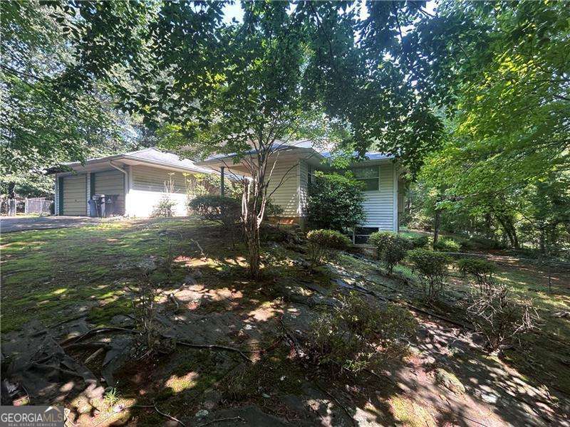 Fixer-Upper Opportunity in Prime Location with 2 acres! This is your chance to own rare gem in Roswell - a diamond in the rough nestled on an incredible 2-acre lot. NO HOA. Featuring 4 bedrooms, and 3 full bathrooms, this home includes a primary suite on the main level, offering convenience and flexibility in layout. This unique home even has its own ATRIUM in center of the home. The unfinished basement opens up even more potential for added living space, in-law suite, or storage. the canvas is yours. With solid bones and a layout full of potential, this home is ready for your vision. Renovate and create your dream estate or flip and take advantage of the highly desirable location and large acreage - an ideal find for a savvy investors and builders. Convenient to top schools, parks, shopping, and dining. This is the ultimate fixer-upper with serious upside - don't miss your change to bring this Roswell treasure back to life.