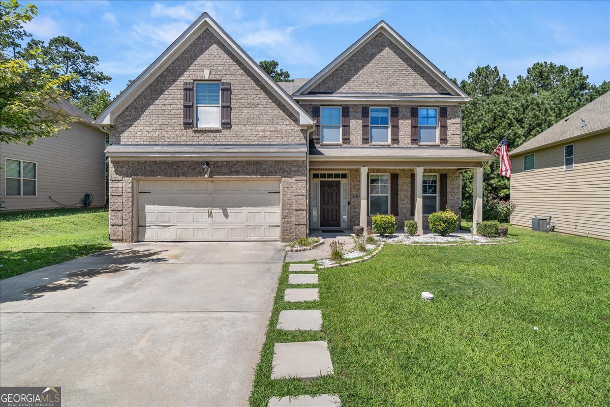 Welcome to this spacious 5-bedroom, 3-bath home on a lake lot in Poplar Falls. Built in 2013, this residence offers nearly 3,700 sq ft - the largest floor plan in the subdivision - blending classic architecture with modern upgrades. Highlights include a two-story foyer, coffered dining room, formal living, open-concept family room with fireplace, and a kitchen with granite countertops, stainless steel appliances, island, pantry, and wine cooler. The primary suite features a sitting area with a two-sided fireplace, bay windows, tray ceiling, dual vanities, soaking tub, separate shower, and two walk-in closets. Additional bedrooms, full baths, upstairs laundry, 2-car garage, built-in speakers, and security with 360o view cameras add convenience. Outdoors, enjoy a wooded backdrop with seasonal lake views. Seller's Home Warranty provided by Achoa Home Warranty, giving all parties added confidence that major systems and appliances are covered during the transaction.