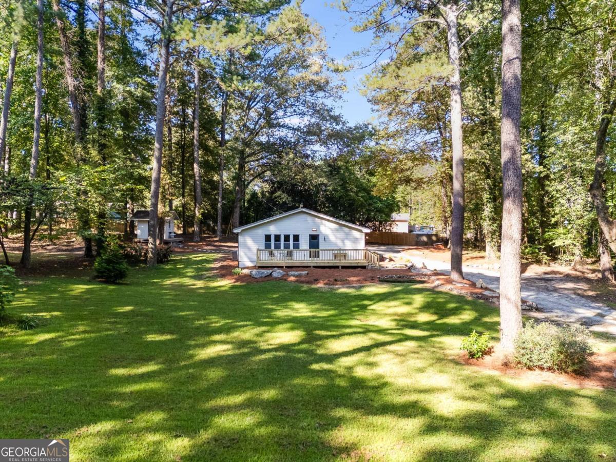 If you're looking for an updated home that has been done with care, attention to detail and functionality in mind than look no further! On 1.21 acres this house has so many opportunities that come with it, all that's missing is someone to make it their own. The freshly built front deck is a nice place to sit and watch the cars go by or enjoy a drink and enjoy nature. Walking in you'll see newly added LVP flooring that goes well with the style of the house, the large living room is the perfect place to entertain or to just relax and watch tv by the fireplace. The isolated master suite has nice privacy and features a double vanity along with a tiled shower and a walk-in closet. The common area is well connected to the eat-in kitchen and the 2nd full bathroom, along with the 2nd and 3rd bedroom. The kitchen features a granite counter top and new cabinets for lots of storage and a large island for eating. A farm style sink and garbage disposal along with all stainless steel and electric appliances making cooking a joy. So many more things to be excited for in this house, such as, all new lighting, new A/C unit, drop down attic access, paved rear patio, new washer/dryer combo, and a fully finished work shed. All that this home in missing is someone to make it theirs.