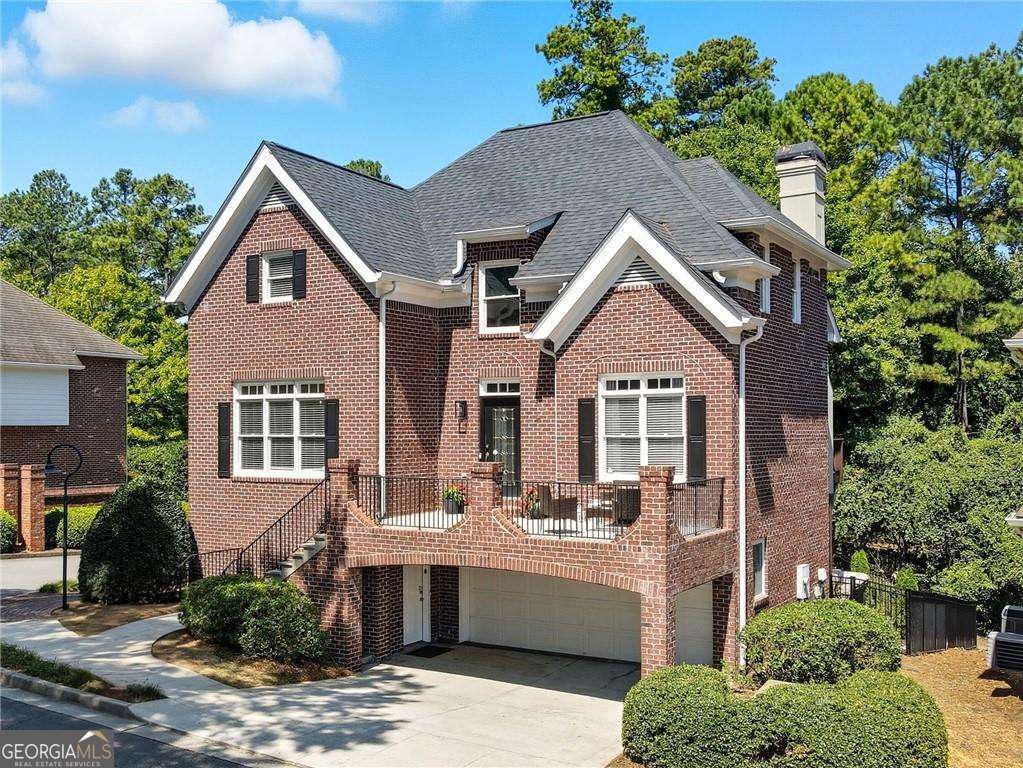 Discover this stunning four-sided brick showpiece in the coveted enclave of Fairway Gardens at Lenox Park, walking distance to the sweeping views of the Buckhead skyline and a lifestyle that blends elegance, convenience, and comfort. Step inside the soaring two-story foyer to find a bright, open living area drenched in natural light and anchored by a custom-designed, floor-to-ceiling bookshelf that's nothing short of spectacular. The chef's kitchen features expansive granite counters that flow into a generous barstool dining area-perfect for everyday living or entertaining. The main level also offers a flexible bedroom/office with charming arched wooden doors and a clever custom Murphy bed encased in floor-to-ceiling cabinetry, making it as practical as it is beautiful. Upstairs, retreat to the luxurious primary suite with its oversized walk-in closet and spa-like bath complete with double vanity, soaking tub, and separate shower. A spacious secondary suite with its own walk-in closet and en-suite bath completes the upper level. The terrace level is an entertainer's dream-a stylish built-in bar with shelving, a full bedroom and bath, and seamless access to a brand-new outdoor patio designed for gatherings under the stars. With over $100K in thoughtful upgrades, including a new roof (2023), fresh paint, upgraded lighting, new patio, professional landscaping, full basement remodel, and more, this home is truly move-in ready. And the location? Unbeatable. Walk to MARTA, Lenox Mall, Phipps Plaza, and some of Atlanta's best restaurants and shopping and parks-all from your private, serene community. This is more than a home-it's a lifestyle. Don't miss it!