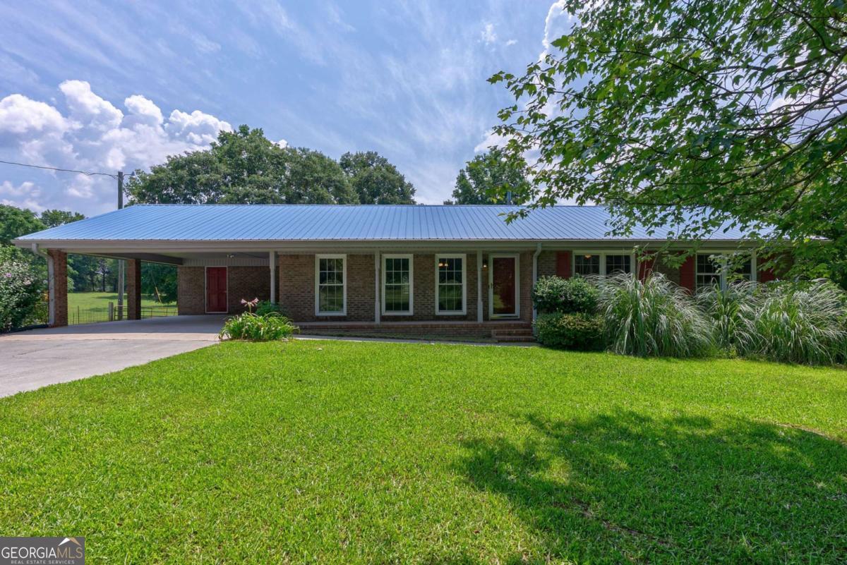 Welcome to 1131 Treadwell Bridge Rd a lovingly maintained 3 bed, 2 bath home nestled on 5.65 acres of picturesque pasture land in sought-after Oconee County, home to one of the top public school systems in the nation. With approximately 2,000sqft of living space, this single-family gem offers the perfect blend of peaceful country living and everyday convenience. Step into the sunroom, where exposed brick walls creates a warm, inviting space perfect for enjoying your morning coffee, reading in the afternoon light, or simply soaking in the view. The kitchen features beautiful wooden cabinetry, a brand-new microwave, stove, and oven. There is space for a breakfast table along side the kitchen area. Walking through the carport door where the pantry/laundry room giving you both functionality and charm. The bathrooms also feature matching rich wood cabinetry, and the entire home is filled with natural light, making every room feel bright, open, and welcoming. You will appreciate the pristine condition throughout, including a new HVAC system installed in 2023. Outside, enjoy wide-open views of your private pasture, a 1,200sqft storage shed that is insulated with 2 garage doors for all of your hobbies and projects, and a private well. The driveway is concrete and large accommodating many vehicles Whether your gardening, relaxing under the stars, or watching deer wander across the field, this home offers a peaceful retreat just minutes from Hwy 78, Hwy 53 and Hwy 316. Additional purchase options available contact agent for details. Please do not access the pasture without permission from the listing agents.