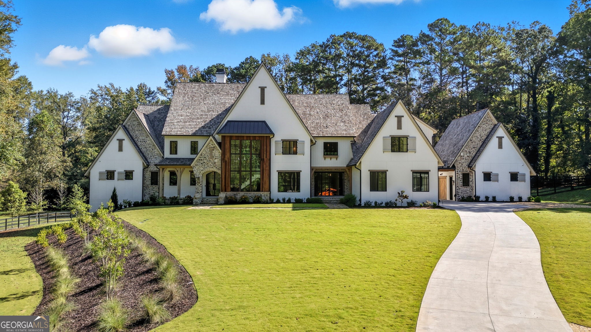 Beautiful Custom Home on gorgeous estate lot in exclusive Milton. This amazing European Provencal cement stucco and stone home combines all the Traditional luxuries with Modern style. This estate home is situated on a private 4.48 acre lot. The Open Concept floor plan has a custom modern Staircase visible from the front through the dramatic black framed two story window. Upon entering the Iron Framed double doors the two story Family room opens to the beautiful backyard. As you walk out the main level into The backyard Oasis, complete with expansive Travertine patio you look out to the beautiful pool, and spa facing the private woods with a creek in the distance. Pool bathroom is just one of the details this home includes. The Chef's kitchen has a dramatic marble island which opens to the Family Room and Keeping Room. Kitchen Boasts a 60" Wolfe Duel Fuel Range, Two Miele Dishwashers, Sub Zero Refrigerator and Separate Freezer, Large pantry, Butlers pantry, and Mud Room. This home has Two Laundry Rooms. The main floor includes an Owner's Suite with separate sitting room, which has private balcony. Large bathroom, which also opens to balcony, and amazing His and Hers closets. The Guest En Suite, also on main, has its own door leading to the back guest terrace over looking small fountain. There are 3 additional bedrooms upstairs with private baths and an oversized bonus room. The finished Terrace level includes an Office, Exercise Room, Steam Shower, Cold Plunge Room, Bar, Theatre Room, and tons of storage! This is an amazing Home for Entertaining. 3 Car garage and an additional separate 2 Car Garage with option of future teen or in-law suite above. Amazing Milton location! Minutes from Down Town Alpharetta and Avalon! Great Schools! Professional photos coming soon!
