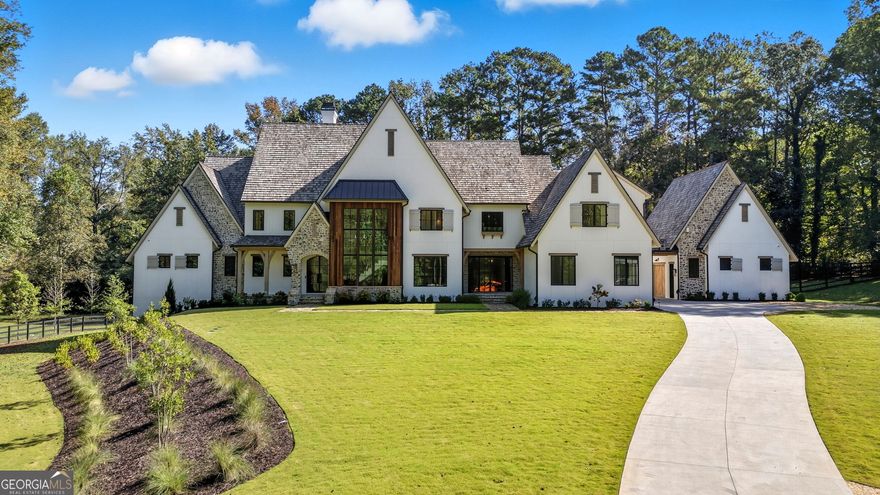 Beautiful Custom Home on gorgeous estate lot in exclusive Milton. This amazing  European Provencal cement stucco and stone home combines all the Traditional luxuries with Modern style. This estate home is situated on a private 4.48 acre lot. The Open Concept floor plan has a custom modern Staircase visible from the front through the dramatic black framed two story window. Upon entering the Iron Framed double doors the two story Family room opens to the beautiful backyard. As you walk out the main level into The backyard Oasis, complete with expansive Travertine patio you look out to the beautiful pool, and spa facing the private woods with a creek in the distance. Pool bathroom is just one of the details this home includes. The Chef's kitchen has a dramatic marble island which opens to the Family Room and Keeping Room. Kitchen Boasts a 60" Wolfe Duel Fuel Range, Two Miele Dishwashers, Sub Zero Refrigerator and Separate Freezer, Large pantry, Butlers pantry, and Mud Room. This home has Two Laundry Rooms. The main floor includes an Owner's Suite with separate sitting room, which has private balcony. Large bathroom, which also opens to balcony, and amazing His and Hers closets. The Guest En Suite, also on main, has its own door leading to the back guest terrace over looking small fountain. There are 3 additional bedrooms upstairs with private baths and an oversized bonus room. The finished Terrace level includes an Office, Exercise Room, Steam Shower, Cold Plunge Room, Bar, Theatre Room, and tons of storage! This is an amazing Home for Entertaining. 3 Car garage and an additional separate 2 Car Garage with option of future teen or in-law suite above. Amazing Milton location! Minutes from Down Town Alpharetta and Avalon! Great Schools! Professional photos coming soon!