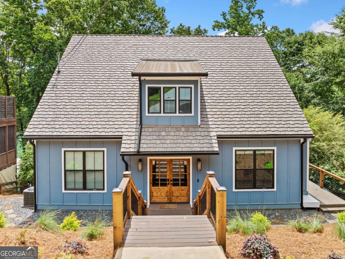 Perched in the coveted 6-mile cove on Lake Lanier, this impeccable fully renovated home offers an unparalleled lakeside retreat. Boasting prime deep water access and easy proximity to 400 and local amenities, this residence is a true gem. The main level exudes elegance with 10 foot ceilings and a flowing open concept. Featuring a serene master bedroom with direct access to the large covered deck and stunning lake views. The master bath indulges with double vanities, oversized shower, and a walk-in closet, ensuring privacy and luxury. The kitchen, adorned with beautiful new cabinets, countertops, and top grade appliances, seamlessly opens to the living area, creating a perfect space for both relaxation and entertainment. Upstairs, two spacious bedrooms with high vaulted ceilings and a stylish bathroom offer comfort and charm, each equipped with its own HVAC and dormer windows providing ample light and sweeping lake views. The terrace level is also new construction, fully renovated, presents a bedroom, an office, ample storage, and a full bath, ideal for unwinding after a day on the lake or creating a versatile space for recreation. Custom top-grade finishes adorn every aspect of this home, from the windows and doors to the roof with top-grade synthetic shake Davinci shingles with 50 year warranty, high end copper roofing and metal accents. Grandfathered in 42 ft. double slip boat dock with covered slips and an uncovered platform for sunbathing. The entire home has a rockwool sound barrier in every wall. There are tons of upgrades, list of upgrades is attached to documents. This is the epitome of a premium lake house on Lake Lanier with a deep water dock.Mostly new construction with the exception of the basement. All electrical and plumbing is new. Entire home, including ceiling and roof, is encapsulated in cell foam insulation, which causes high efficiency. The kitchen, adorned with beautiful new cabinets, countertops, and top grade appliances, seamlessly opens to the living area, creating a perfect space for both relaxation and entertainment. Upstairs, two spacious bedrooms with high vaulted ceilings and a stylish bathroom offer comfort and charm, each equipped with its own HVAC and dormer windows providing ample light and sweeping lake views. The terrace level is also new construction, fully renovated, presents a bedroom, an office, ample storage, and a full bath, ideal for unwinding after a day on the lake or creating a versatile space for recreation. Custom top-grade finishes adorn every aspect of this home, from the windows and doors to the roof with top-grade synthetic shake Davinci shingles with 50 year warranty, high end copper roofing and metal accents. Grandfathered in 42 ft. double slip boat dock with covered slips and an uncovered platform for sunbathing. The entire home has a rockwool sound barrier in every wall. There are tons of upgrades, list of upgrades is attached to documents. This is the epitome of a premium lake house on Lake Lanier with a deep water dock.Mostly new construction with the exception of the basement. All electrical and plumbing is new. Entire home, including ceiling and roof, is encapsulated in cell foam insulation, which causes high efficiency.